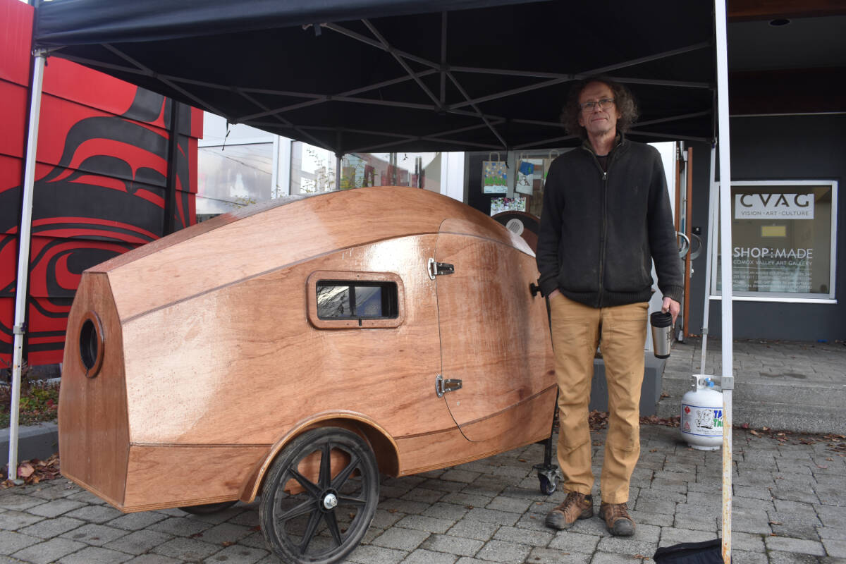 Werner Karsten shows one of the two turtlepod prototypes he brought with him for display at the Walk With Me event in Courtenay, on Nov. 26. The insulated, mobile  pods are intended to provide safe shelter for those experiencing homelessness. Photo by Terry Farrell