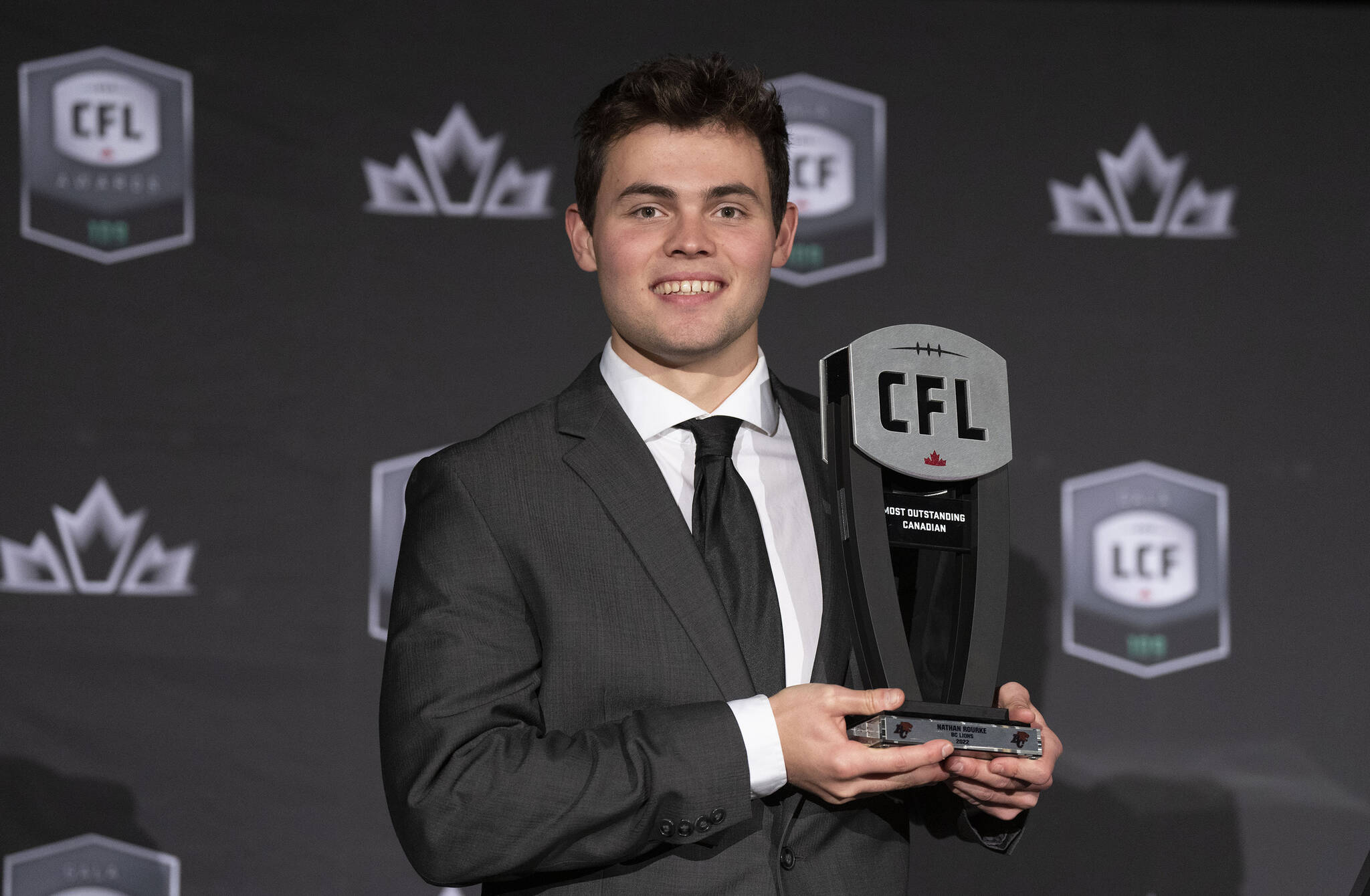 Most outstanding Canadian player, quarterback Nathan Rourke of the BC Lions, holds up his trophy during the CFL Awards in Regina, Thursday, Nov. 17, 2022. THE CANADIAN PRESS/Paul Chiasson