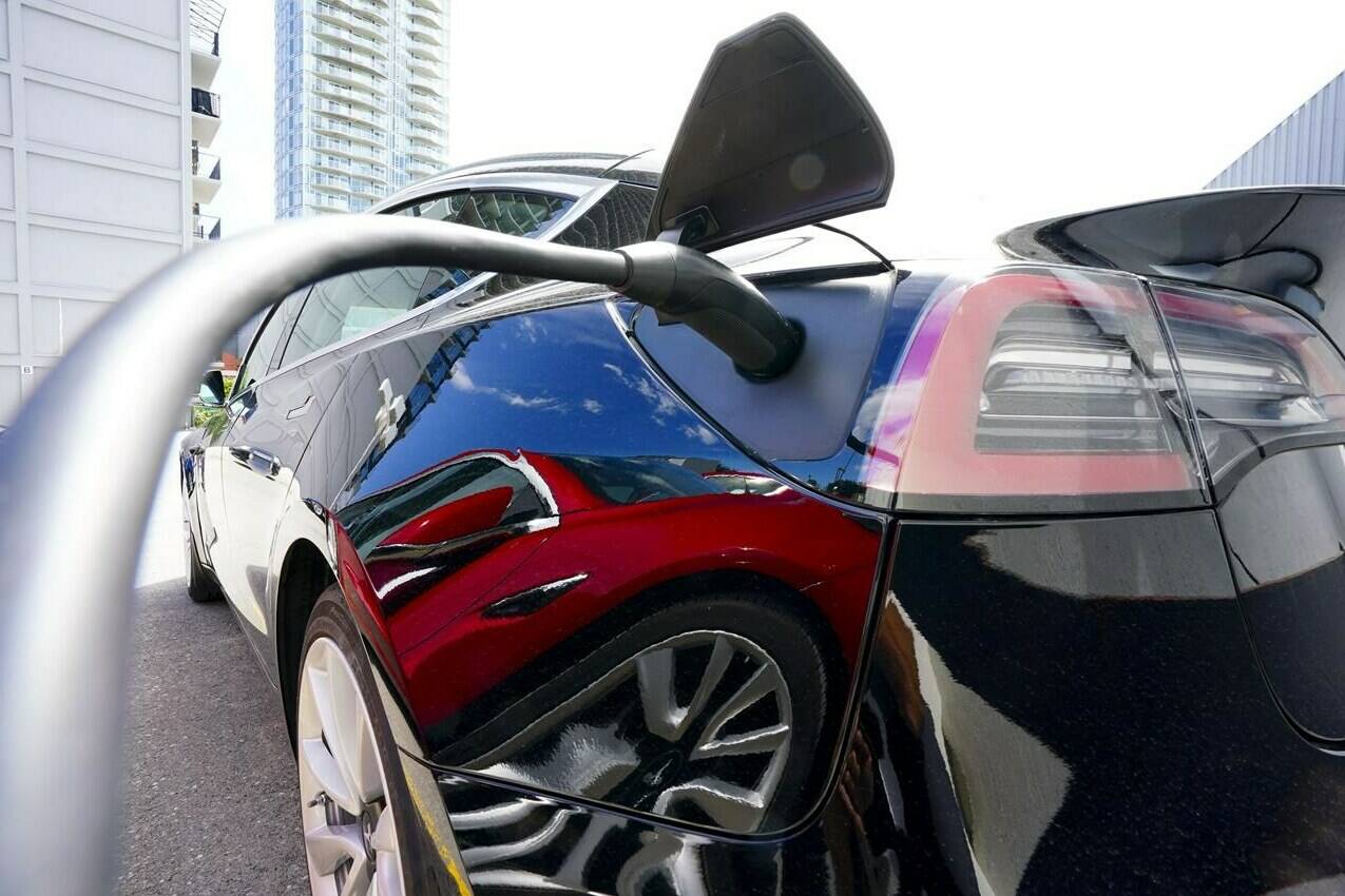 An electric vehicle is charged in Ottawa on Wednesday, July 13, 2022. Parkland Corp. says it is doubling the size of its previously announced electric vehicle charging network in western Canada.THE CANADIAN PRESS/Sean Kilpatrick