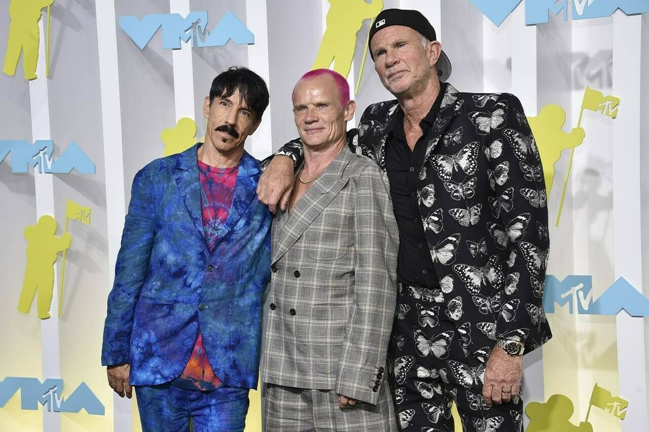 FILE - Anthony Kiedis, from left, Flea and Chad Smith, of Red Hot Chili Peppers, appear at the MTV Video Music Awards on Aug. 28, 2022, in Newark, N.J. Live Nation said Monday the band will perform at a set of stadium shows and festivals across North America and Europe beginning March 29. (Photo by Evan Agostini/Invision/AP, File)