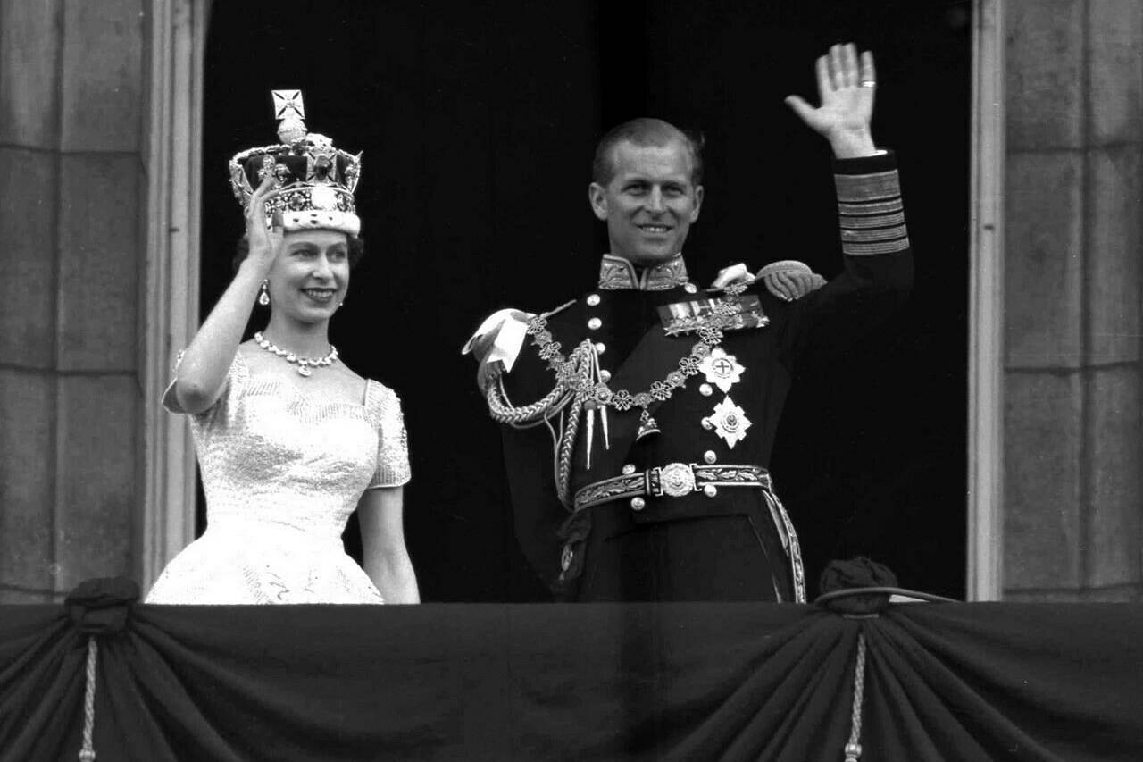 In this June. 2, 1953 file photo, Britain’s Queen Elizabeth II and Prince Philip, Duke of Edinburgh wave to supporters from the balcony at Buckingham Palace, following her coronation at Westminster Abbey, London. TH EVANADIAN PRESS/AP-Leslie Priest