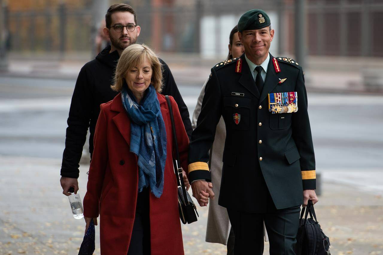 Maj.-Gen. Dany Fortin, right, arrives with his wife Madeleine Collin at a Gatineau, Que. courthouse on Tuesday, Oct. 25, 2022. THE CANADIAN PRESS/Spencer Colby