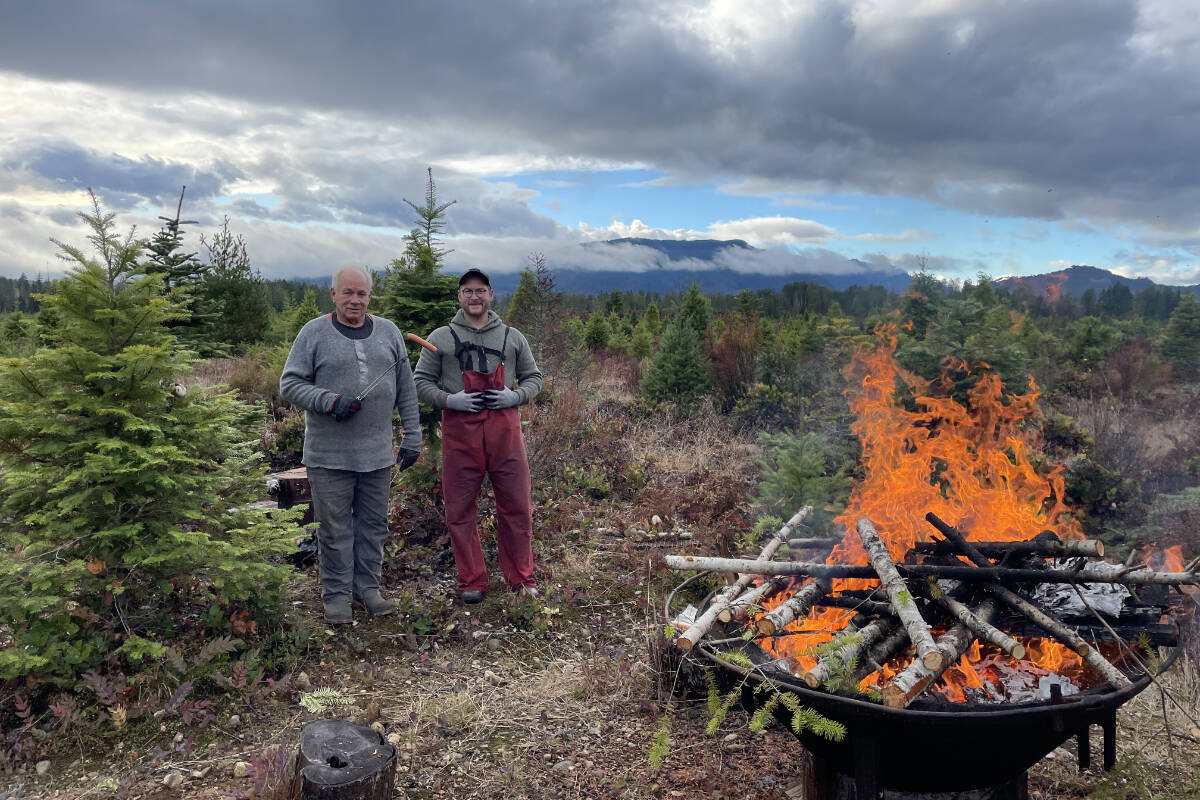 Tom Verbrugge and his son Mica have the bonfire stoked and the hotdogs ready to roast when Tom’s Trees Christmas tree farm opens on Nov. 26, 2022. (PHOTO COURTESY TOM VERBRUGGE)