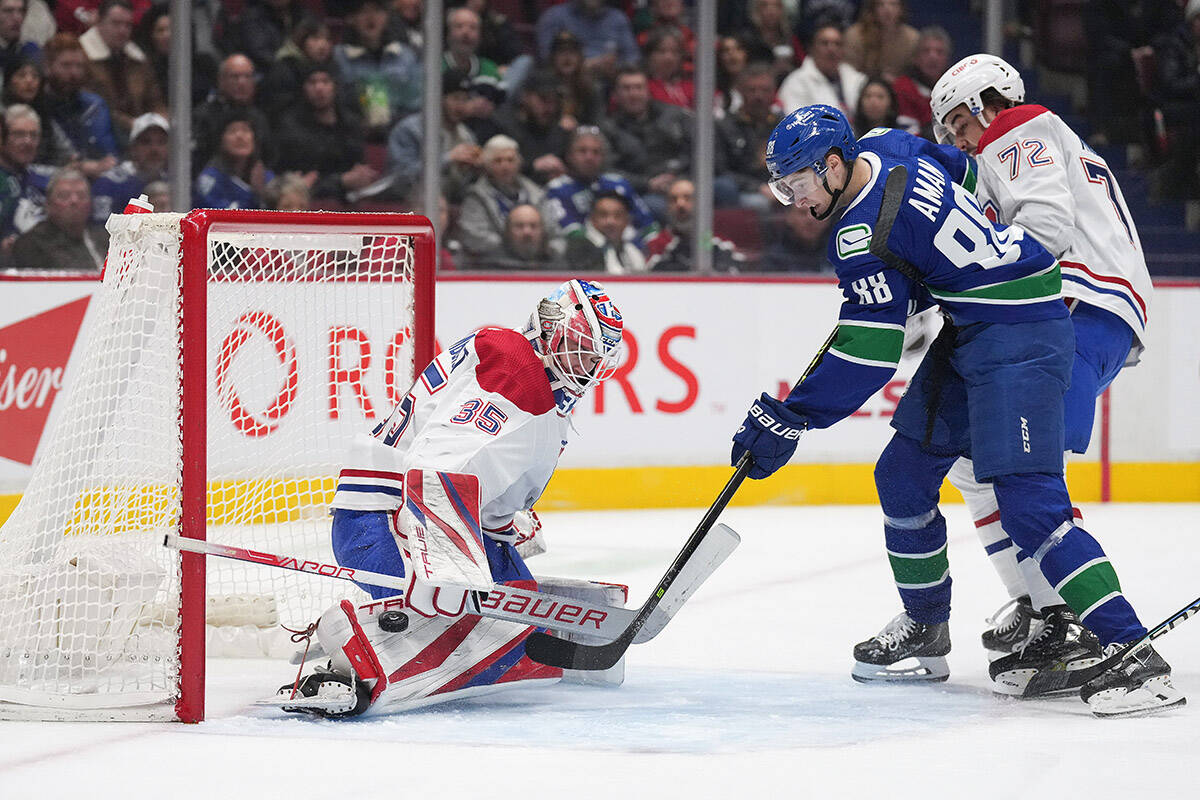 Montreal Canadiens goalie Sam Montembeault (35) stops Vancouver Canucks’ Nils Aman (88), of Sweden, as Montreal’s Arber Xhekaj (72) defends during the first period of an NHL hockey game in Vancouver, B.C., Monday, Dec. 5, 2022. THE CANADIAN PRESS/Darryl Dyck