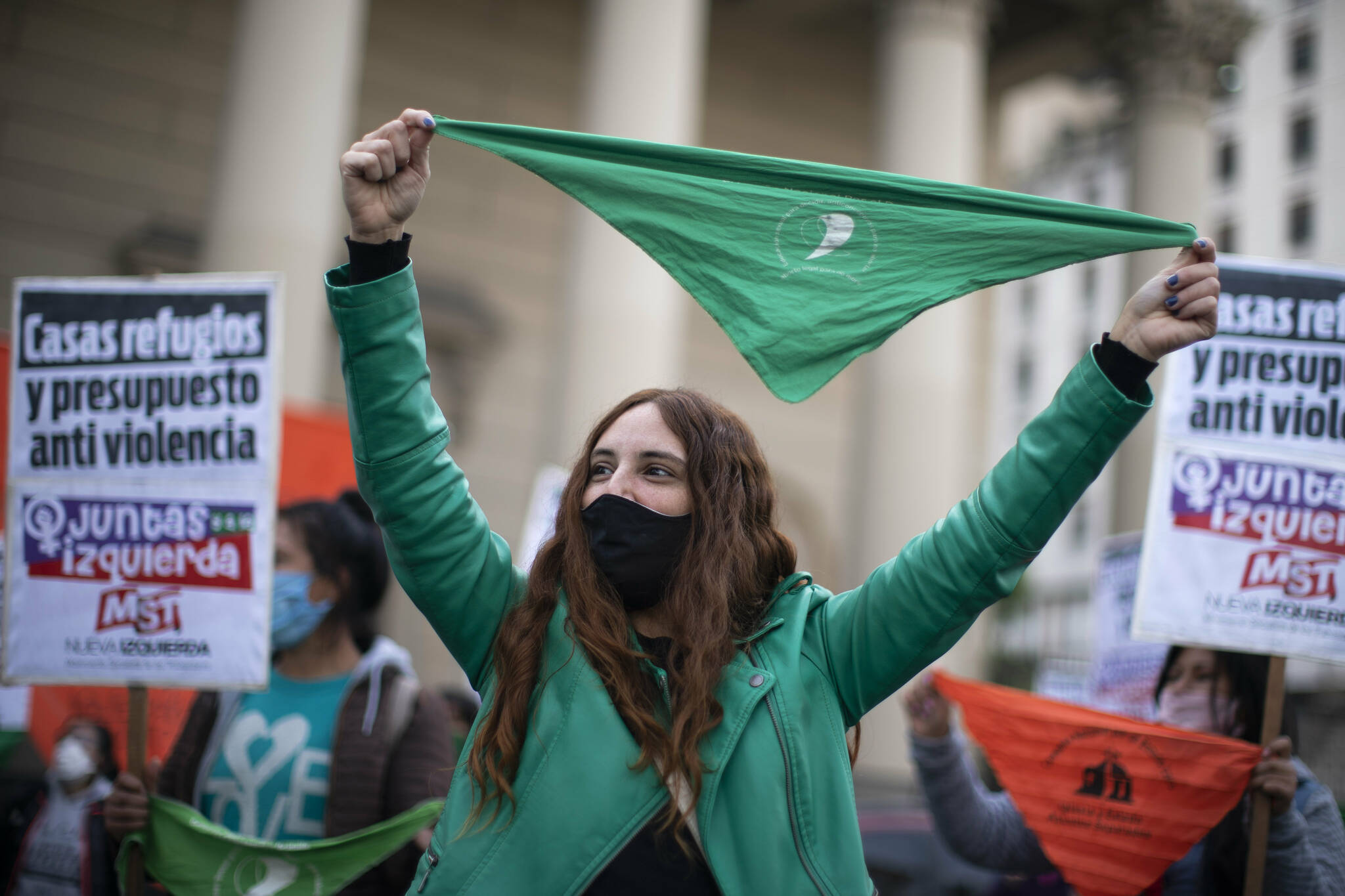 A woman holds a pro-abortion green handkerchief during a protest against gender violence in Buenos Aires, Argentina, on Wednesday, June 3, 2020. The movement “Ni una menos,” or Not One Less marked it’s fifth year anniversary with a protest in Plaza de Mayo during the mandatory COVID-19 lockdown, to demand a stop to femicides, the legalization of abortion, workplace equality, and more budget to protect victims, among other demands. (AP Photo/Victor R. Caivano)