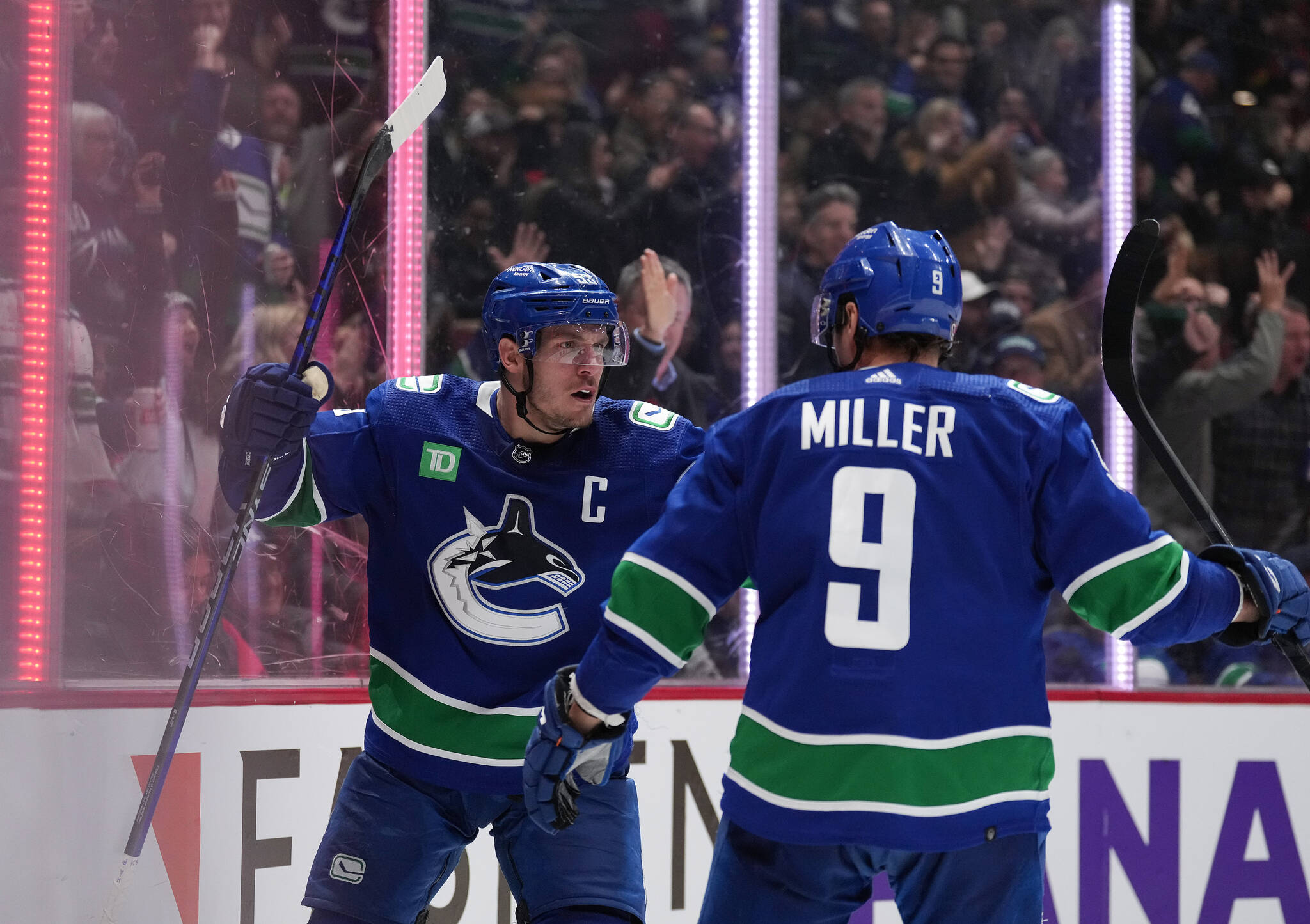 Vancouver Canucks’ Bo Horvat, left, and J.T. Miller celebrate Horvat’s goal against the Montreal Canadiens during the third period of an NHL hockey game in Vancouver, B.C., Monday, Dec. 5, 2022. THE CANADIAN PRESS/Darryl Dyck
