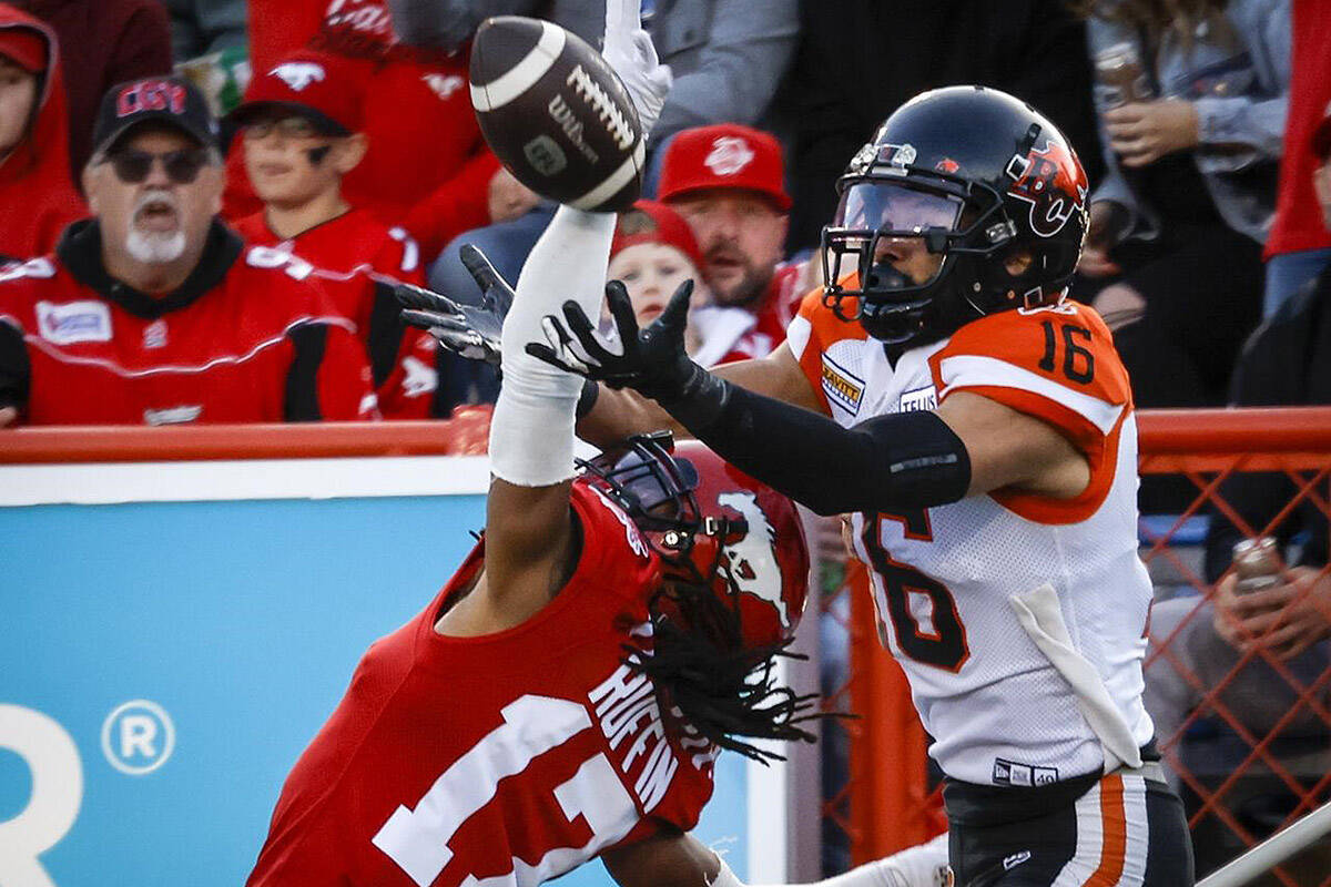 B.C. Lions receiver Bryan Burnham, right, goes up for a pass as Calgary Stampeders defensive back Dionte Ruffin blocks him during second half CFL football action in Calgary, Saturday, Sept. 17, 2022. Burnham has announced his retirement, ending an eight-year career with the CFL franchise. Burnham, a four-time CFL all-star, had 476 receptions and 7,212 receiving yards wit the Lions. Both marks rank fourth in franchise history. THE CANADIAN PRESS/Jeff McIntosh