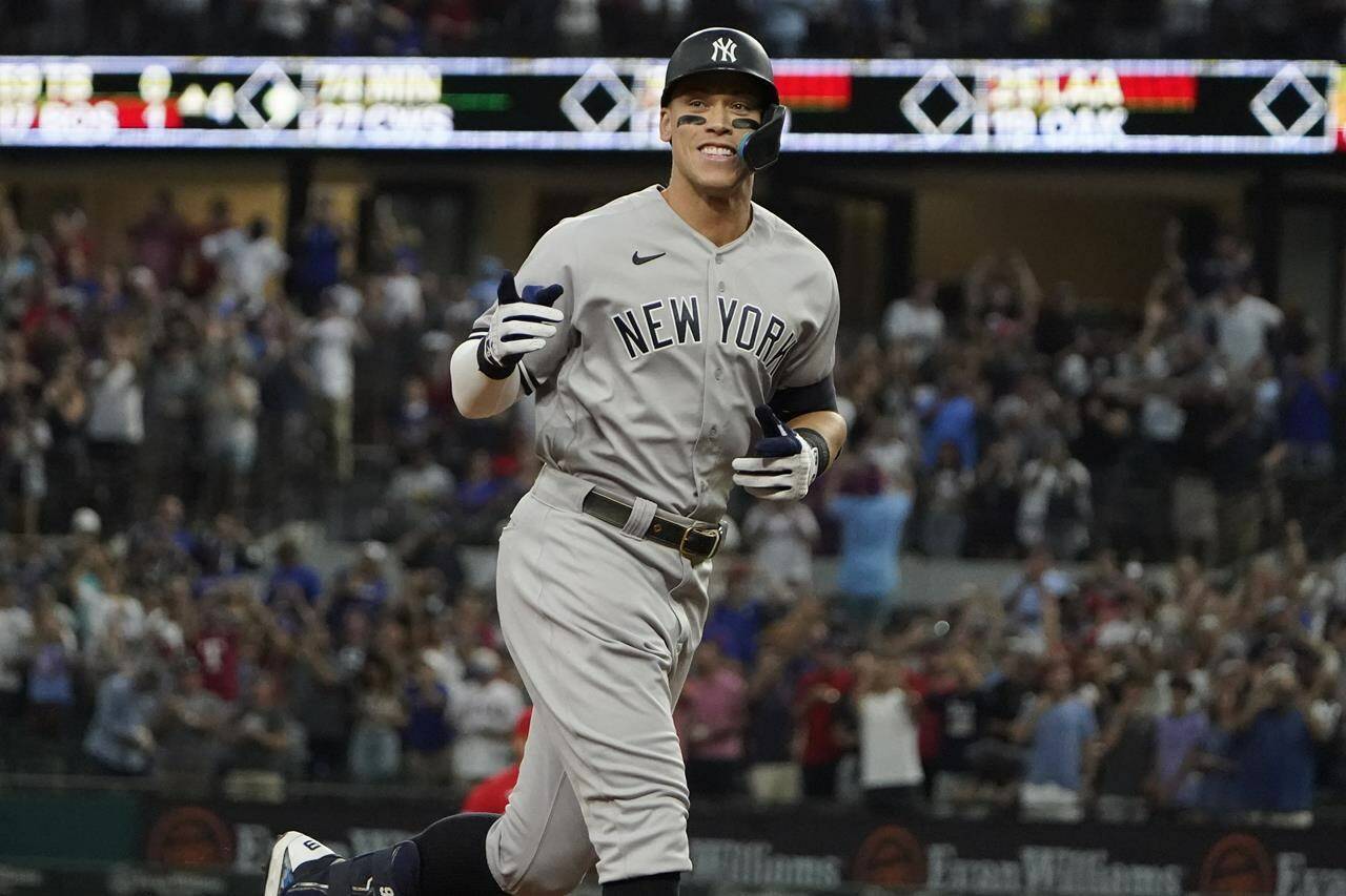 FILE - New York Yankees’ Aaron Judge gestures as he runs the bases after hitting a solo home run, his 62nd of the season, during the first inning in the second baseball game of a doubleheader against the Texas Rangers in Arlington, Texas, Tuesday, Oct. 4, 2022. With the home run, Judge set the AL record for home runs in a season, passing Roger Maris. Judge won the American League MVP Award on Thursday, Nov. 17, 2022, in voting by a Baseball Writers’ Association of America panel. (AP Photo/LM Otero, File)
