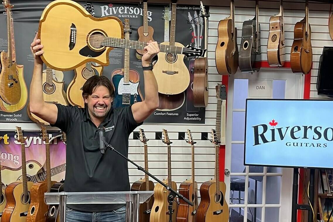 Mike Miltimore, owner of Kamloop’s Riversong Guitars, shown in this handout image, celebrates the company’s P2P River Pacific guitar being named acoustic guitar of the year. It is the first time a Canadian company has won the prestigious international Musical Merchandise Review Dealers’ Choice Award. THE CANADIAN PRESS/HO-Riversong Guitars