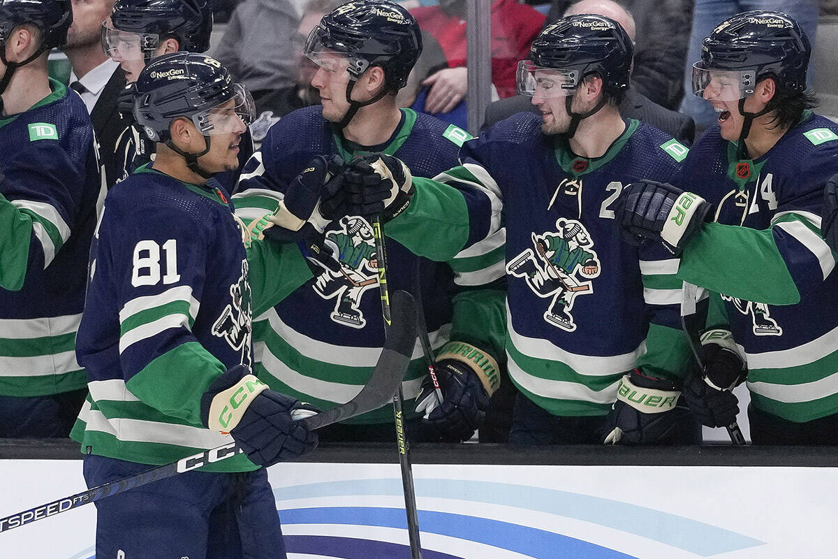 Vancouver Canucks centre Dakota Joshua (81) celebrates with teammates after scoring a goal against the San Jose Sharks during the first period of an NHL hockey game in San Jose, Calif., Wednesday, Dec. 7, 2022. (AP Photo/Godofredo A. VÃ¡squez)