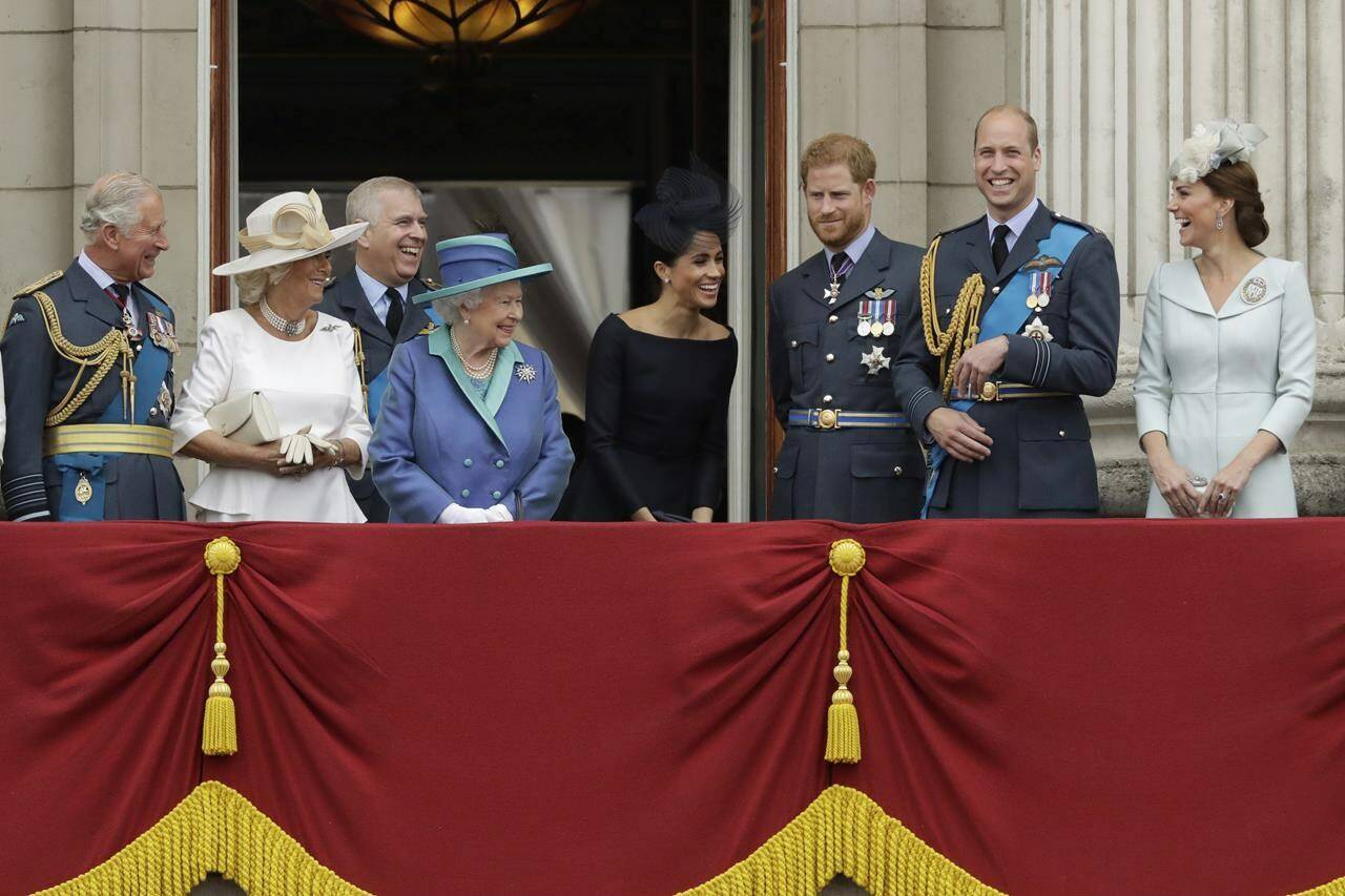 FILE - Britain’s Queen Elizabeth II, at centre left, and from left, Prince Charles, Camilla the Duchess of Cornwall, Prince Andrew, Meghan the Duchess of Sussex, Prince Harry, Prince William and Kate the Duchess of Cambridge, as they watch a flypast of Royal Air Force aircraft pass over Buckingham Palace in London, July 10, 2018. Britain’s monarchy is bracing for more bombshells to be lobbed over the palace gates Thursday, Dec. 8, 2022 as Netflix releases the first three episodes of a series that promises to tell the “full truth” about Prince Harry and Meghan’s estrangement from the royal family. (AP Photo/Matt Dunham, file)