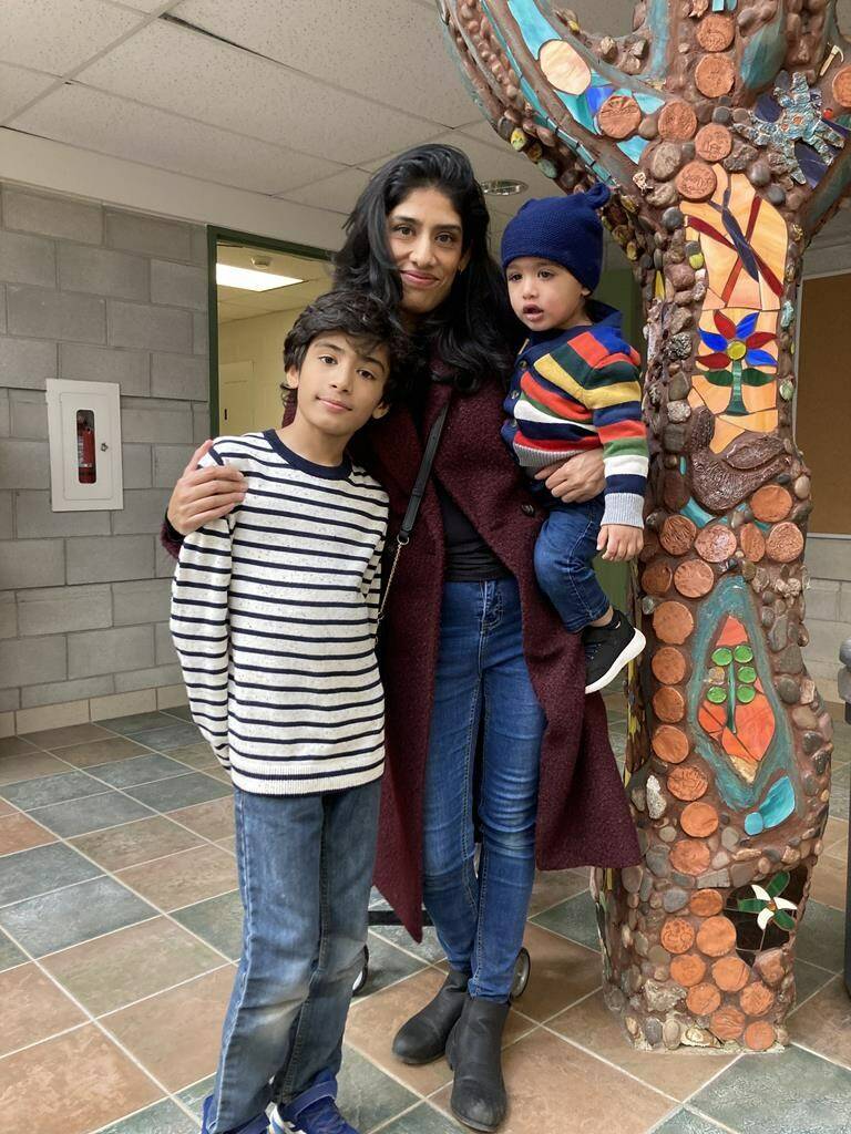 Misha, 40, poses with her kids Krishna, 9, and 15-month-old Surya, in Toronto, in a Thursday, Dec. 8, 2022, handout photo. It has been a challenging year financially for many Canadians grappling with decades-high inflation and soaring interest rates. THE CANADIAN PRESS/HO-Tasneem Patla, *MANDATORY CREDIT*
