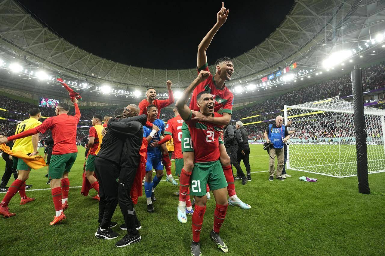 Morocco’s players celebrate after winning the World Cup quarterfinal soccer match between Morocco and Portugal, at Al Thumama Stadium in Doha, Qatar, Saturday, Dec. 10, 2022. (AP Photo/Martin Meissner)