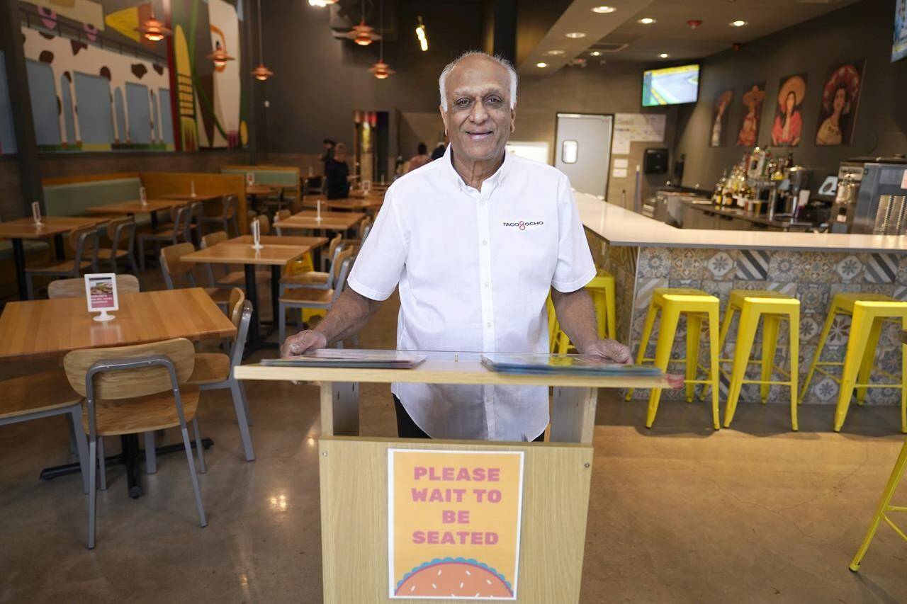 Mani Bhushan, owner of Taco Ocho, poses at one of his restaurants in McKinney, Texas, Friday, Nov. 11, 2022. Bhushan struggles to hire workers in the McKinney location, which opened in July 2021. He said many workers can’t afford to live in this upscale suburb and have to travel from elsewhere. (AP Photo/LM Otero)