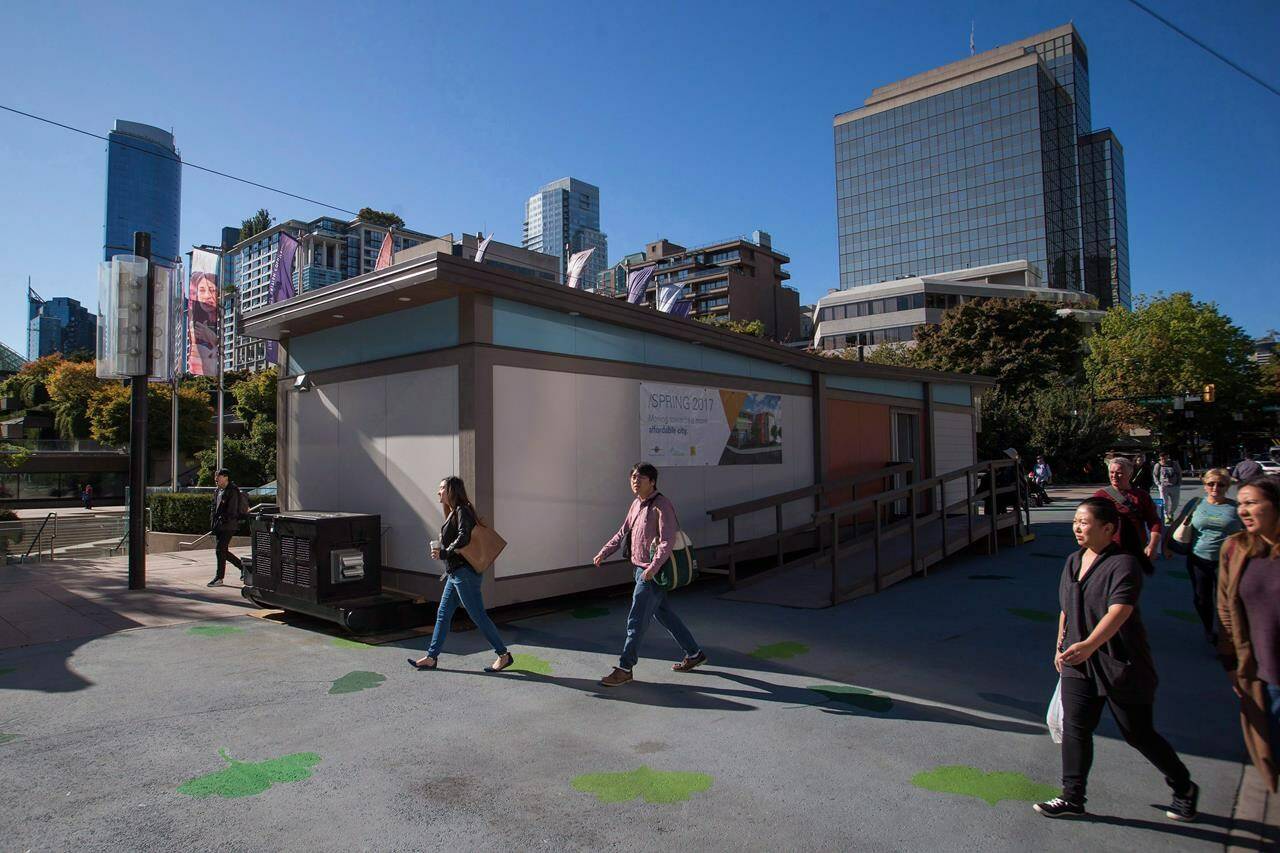 British Columbia’s new Housing Ministry says the province is partnering with the City of Vancouver to build 90 modular housing units in two locations with round-the-clock supports for people experiencing homelessness in the Downtown Eastside. A temporary modular housing suite is visited by the public while on display in Robson Square in downtown Vancouver on Oct. 3, 2017. THE CANADIAN PRESS/Ben Nelms