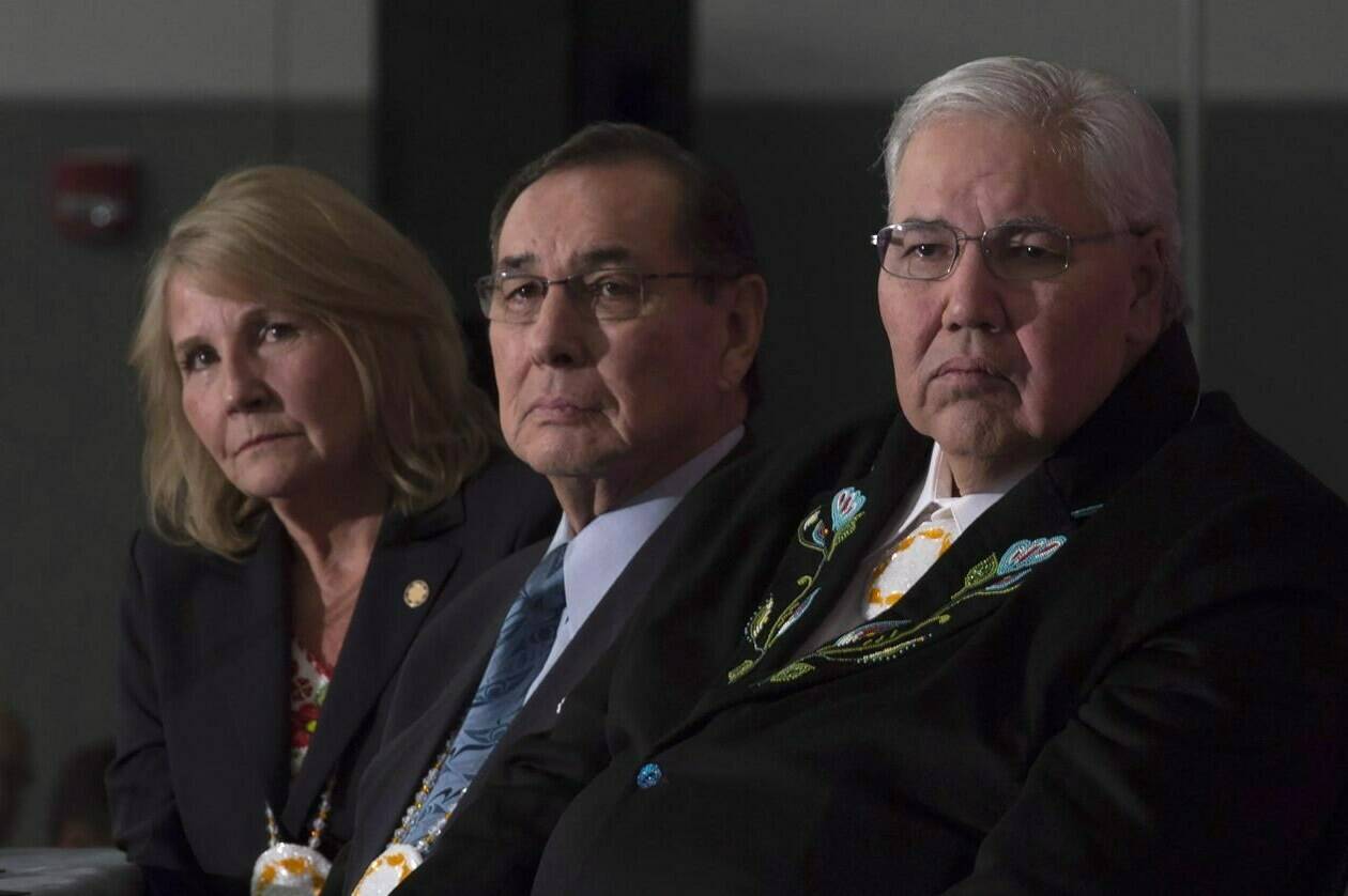 Commissioner Justice Murray Sinclair, Commissioner Chief Wilton Littlechild and Commissioner Marie Wilson (right to left) listen to a speaker as the final report of the Truth and Reconciliation commission is released, Tuesday, Dec. 15, 2015 in Ottawa. Seven years later, an Indigenous-led think tank says progress is moving at a “glacial pace.”THE CANADIAN PRESS/Adrian Wyld