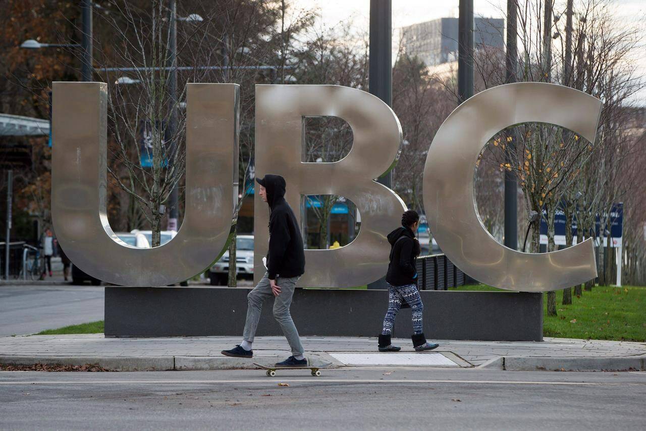 People pass by large letters spelling out UBC at the University of British Columbia in Vancouver on Nov. 22, 2015. Four British Columbia universities will receive $4.3 million from a government research and innovation program to help fund projects in the fields of health, technology and natural resources. THE CANADIAN PRESS/Darryl Dyck
