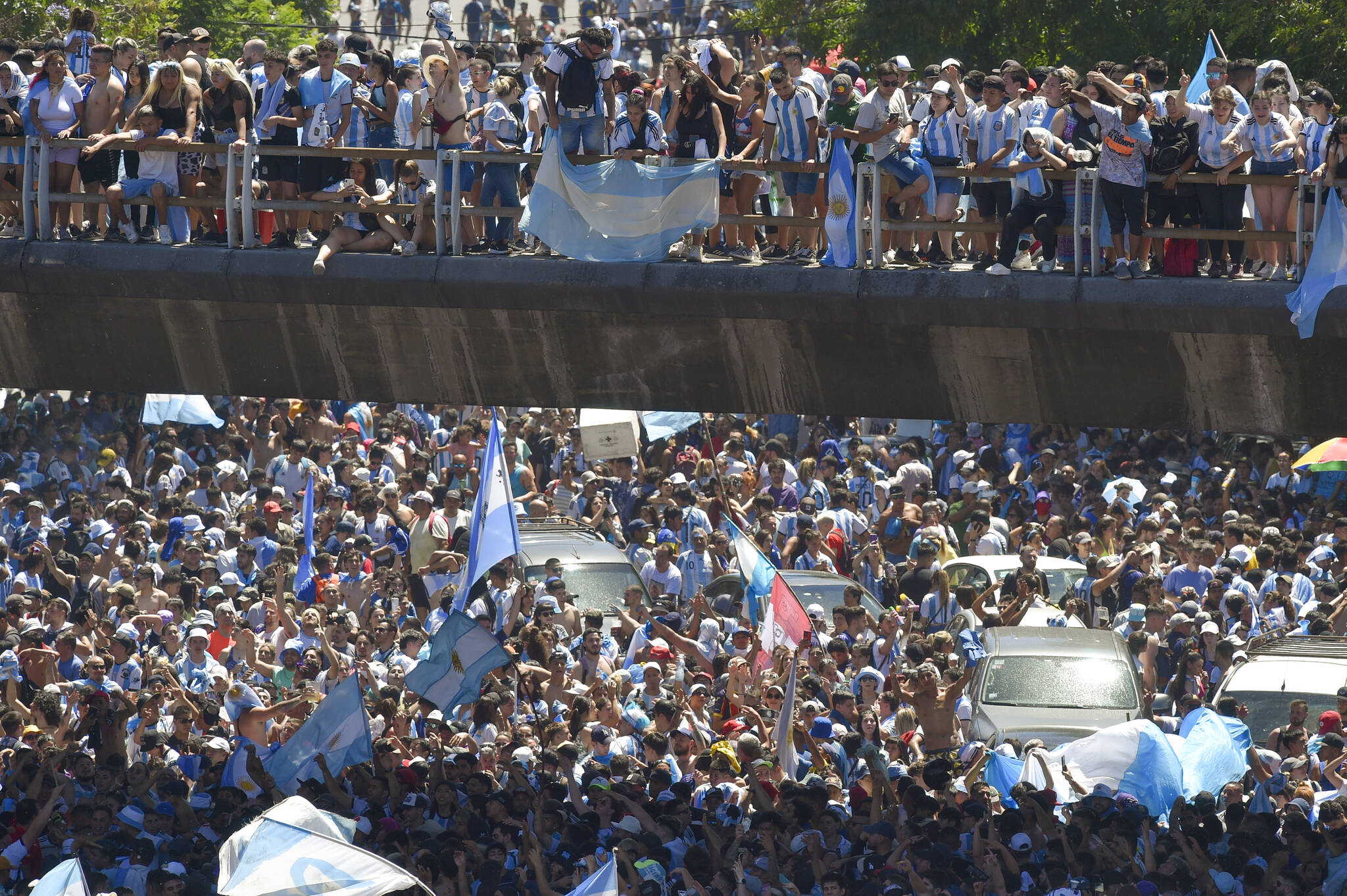 Soccer fans descend on the capital’s downtown for a homecoming parade for the Argentine soccer team that won the World Cup tournament in Buenos Aires, Argentina, Tuesday, Dec. 20, 2022. (AP Photo/Gustavo Garello)