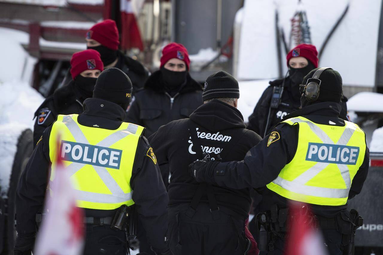 A trucker is led away after leaving his truck as police aim to end an ongoing protest against COVID-19 measures that has grown into a broader anti-government protest, on its 22nd day, in Ottawa, on Friday, Feb. 18, 2022. Ottawa’s Chief of Police says they are making preparations to handle a potential second Freedom Convoy in February 2023. THE CANADIAN PRESS/Justin Tang