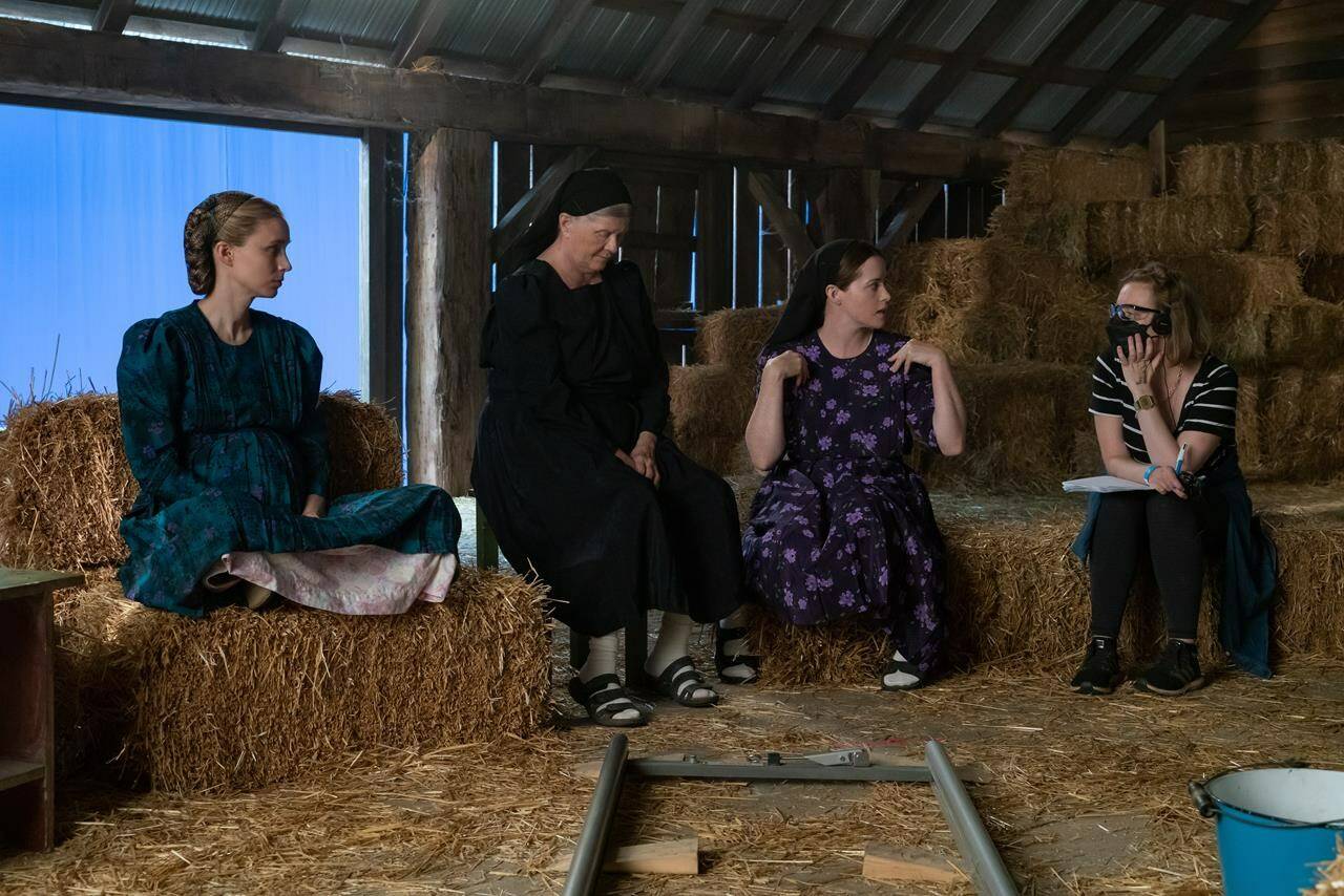 Actors Rooney Mara, left to right, Judith Ivey, Claire Foy and director Sarah Polley talk on the set of their film “Women Talking” in this undated handout photo. THE CANADIAN PRESS/HO, Michael Gibson