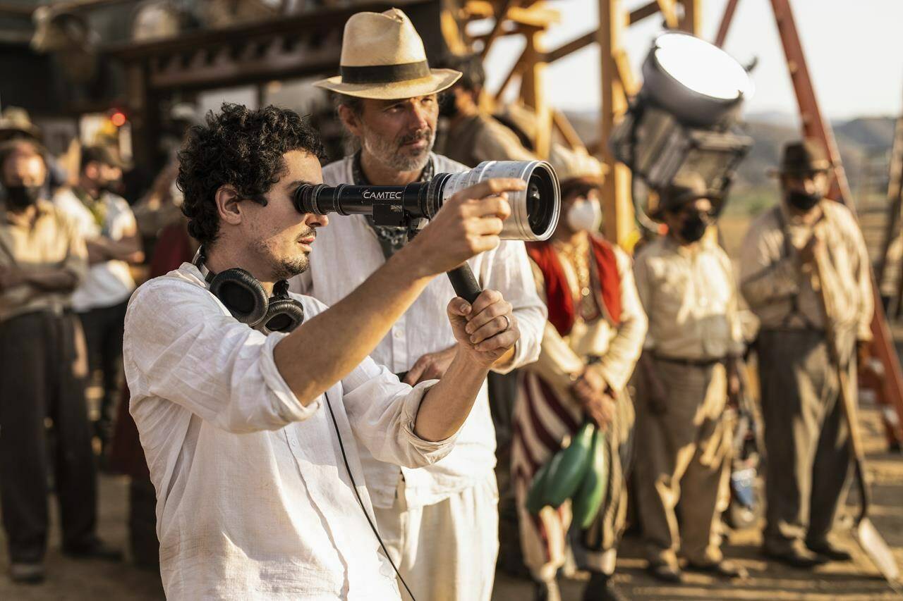 This image released by Paramount Pictures shows director Damien Chazelle, left, and director of photography Linus Sandgren on the set of “Babylon.” (Scott Garfield/Paramount Pictures via AP)