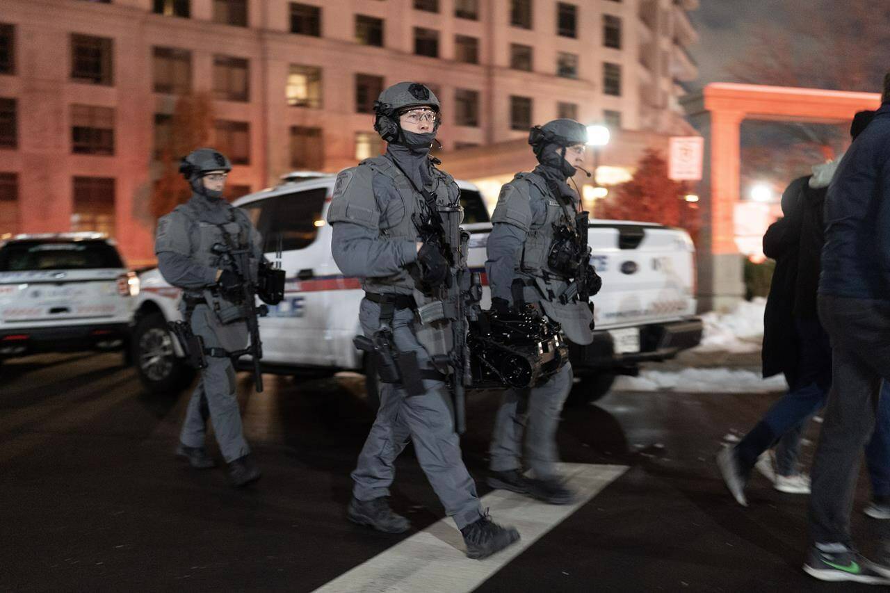 York Regional Police tactical officers attend the scene of a shooting in Vaughan, Ont., Sunday, Dec. 18, 2022. Police north of Toronto are working to determine the motive in what they’ve called a “horrendous” shooting at a condo that left five people, plus the suspected gunman, dead. THE CANADIAN PRESS/Arlyn McAdorey