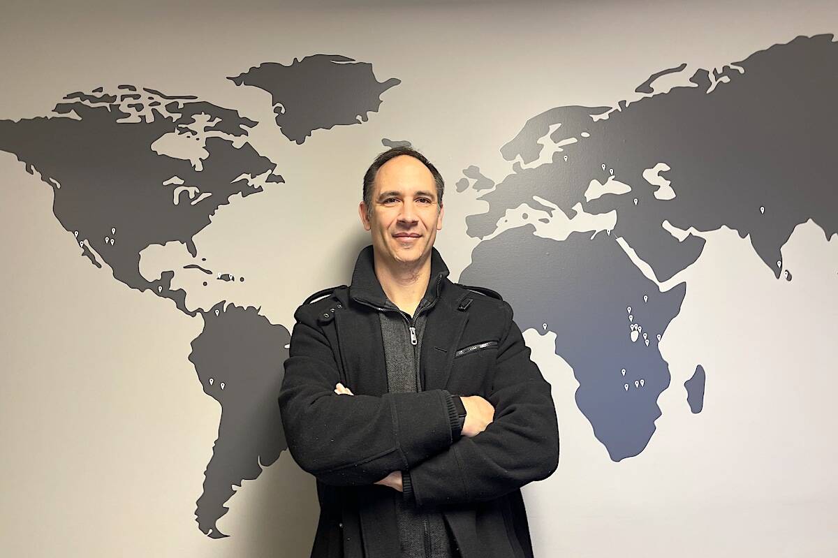 Chad Martz, operations manager, Hungry for Life International, in his Chilliwack office with a map of countries they’ve been to. (Jennifer Feinberg/ Chilliwack Progress)