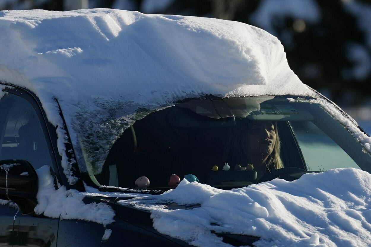 A motorist with snow on their car drives in Richmond, B.C., on Wednesday, Dec. 21, 2022. Warmer weather is set to arrive in parts of British Columbia by Christmas Eve but forecasters warn it’s going to get messy. THE CANADIAN PRESS/Darryl Dyck