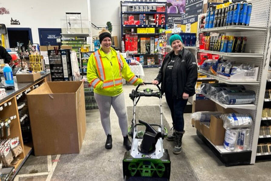 Rona staff at the Hope store pose with a recovered snow blower that was being sold on Facebook Marketplace. (Heather Krentz)