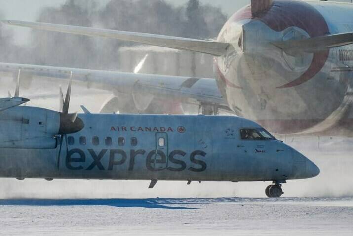An Air Canada aircraft taxis at Vancouver International Airport in Richmond, B.C., on Wednesday, Dec. 21, 2022. A major winter storm is bearing down on Ontario and Quebec, with residents being warned to reconsider travel plans as conditions could get hazardous.THE CANADIAN PRESS/Darryl Dyck