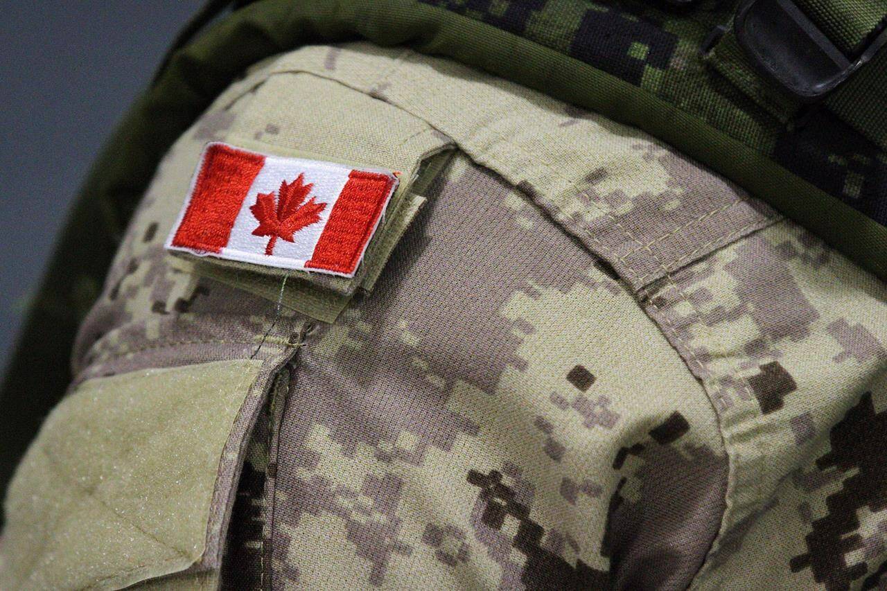 A Canadian flag patch is shown on a soldier’s shoulder in Trenton, Ont., on Thursday, Oct. 16, 2014; THE CANADIAN PRESS/Lars Hagberg