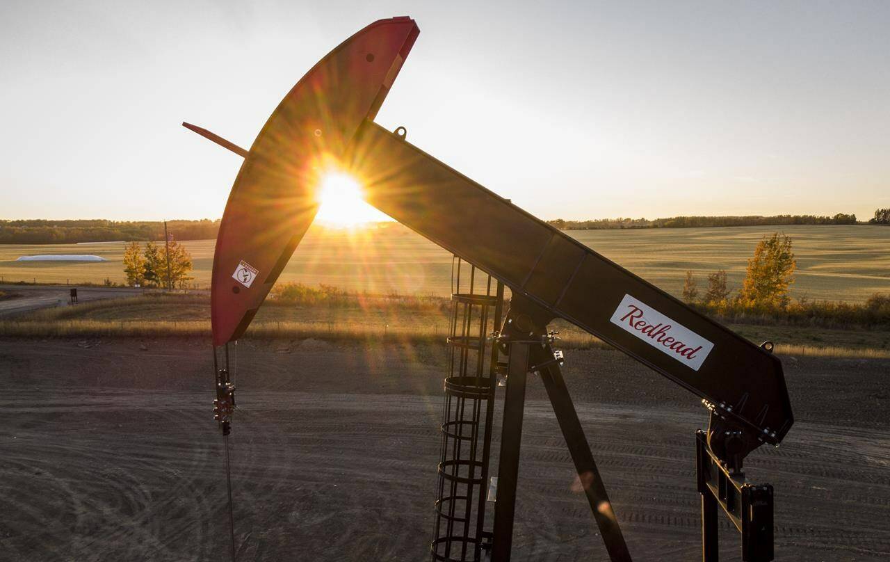 A pumpjack draws out oil and gas from a well head as the sun sets near Calgary, Alta., Sunday, Oct. 9, 2022. Canadian oil and gas companies are expected to increase spending in 2023, but experts say expect another year of modest growth and not a return to boom time levels. THE CANADIAN PRESS/Jeff McIntosh