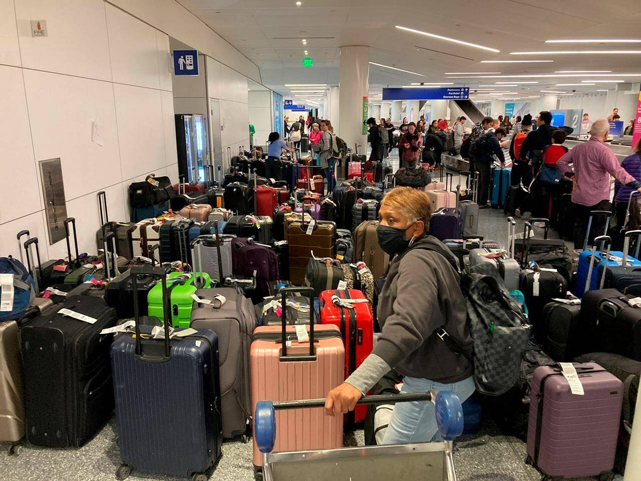 Baggage waits to be claimed after canceled flights at the Southwest Airlines terminal at Los Angeles International Airport on Monday, Dec. 26, 2022, in Los Angeles. (AP Photo/Eugene Garcia)