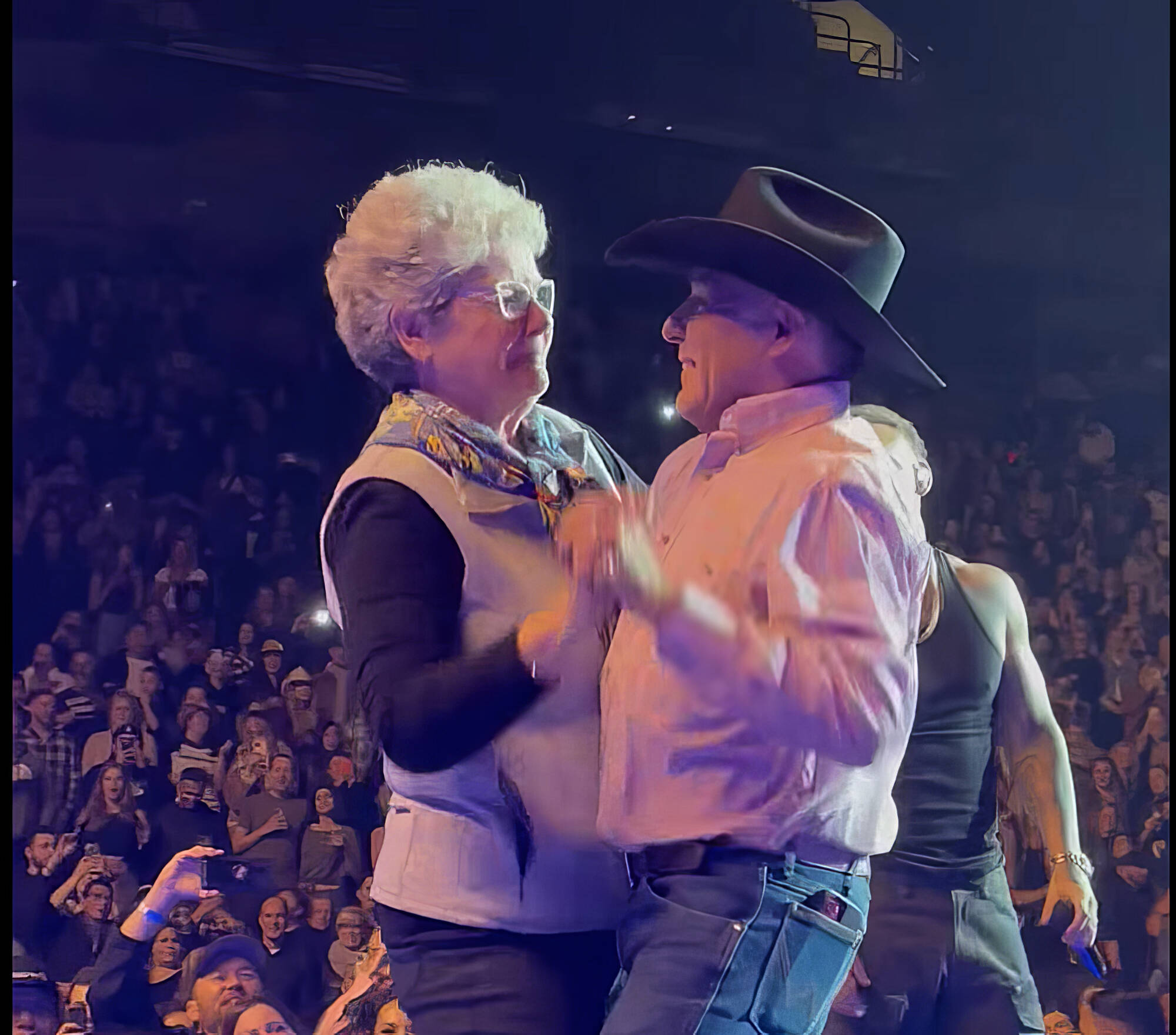 Casey Cawston and Dianne Clifton slowdance on stage while Kane Brown performs in the background on Dec. 15. (Facebook)