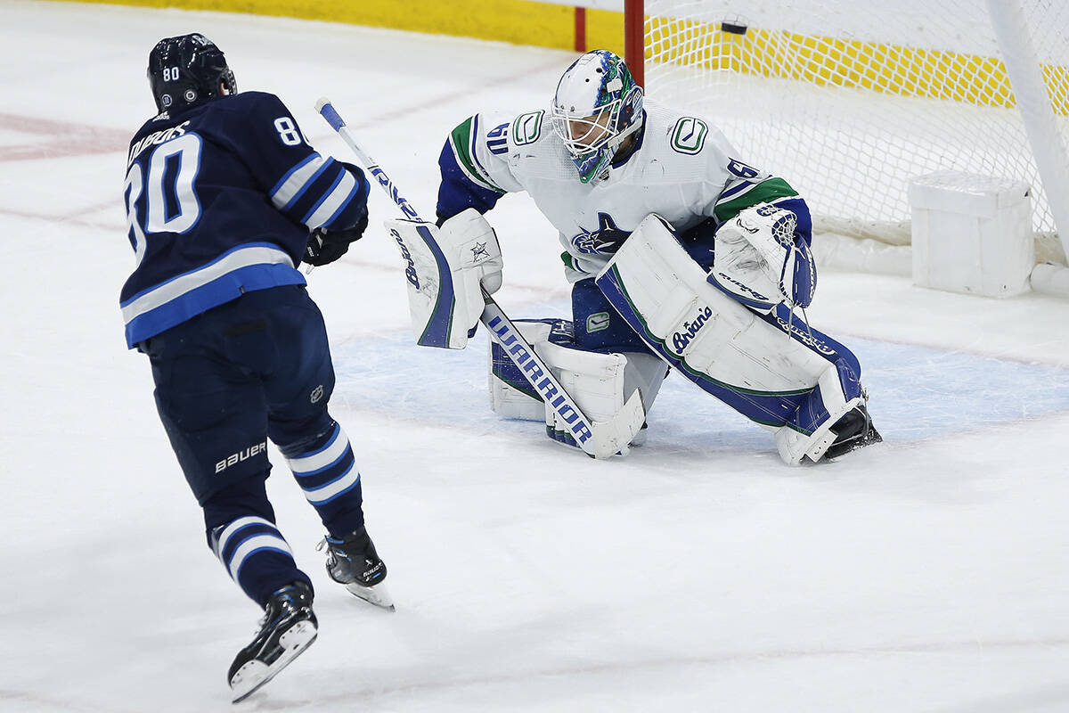 Winnipeg Jets’ Pierre-Luc Dubois (80) scores on a penalty shot against Vancouver Canucks goaltender Collin Delia (60) during second period NHL action in Winnipeg, Thursday, December 29, 2022. THE CANADIAN PRESS/John Woods