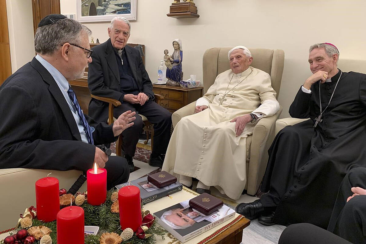 Pope Emeritus Benedict XVI, third from left, meets with the winners of the 2022 Ratzinger Prize, Joseph Halevi Horowitz Weiler, left, and father Michel Fedou, partially hidden at right, at the Mater Ecclesiae monastery inside the Vatican where Benedict XVI lives, in this photo taken Thursday, Dec. 1, 2022. Second from left, is the foundation’s president Father Federico Lombardi, and fourth from left is Benedict XVI’s long-time personal secretary Bishop Georg Gänswein. (Fondazione Vaticana J.Ratzinger via AP)