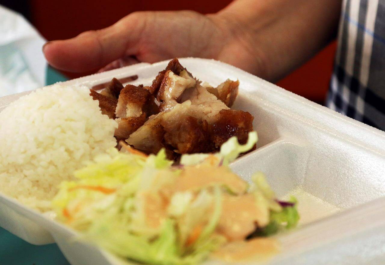 Food is packaged into a polystyrene foam box in Honolulu in a Thursday, March 14, 2019 file photo. Restaurants have been going through months of trial and error in preparation for the phase-in of a federal plastics ban that will eventually aim to remove many single-use plastics, such as takeout containers, from the market altogether. THE CANADIAN PRESS/AP-Audrey McAvoy
