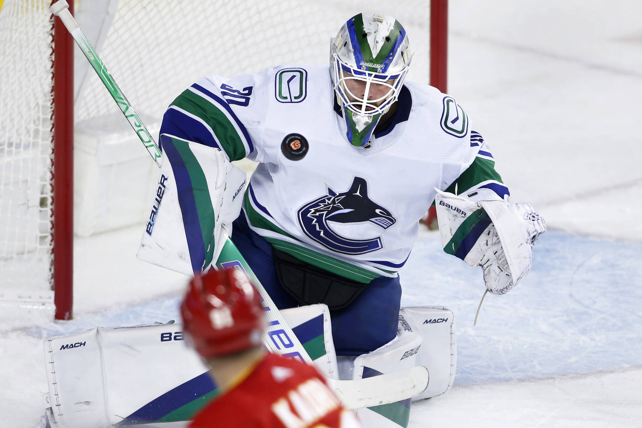 Vancouver Canucks goalie Spencer Martin, (30) makes a save against Calgary Flames’ Nazem Kadri during first period NHL hockey action in Calgary, Alta., Saturday, Dec. 31, 2022. THE CANADIAN PRESS/Larry MacDougal