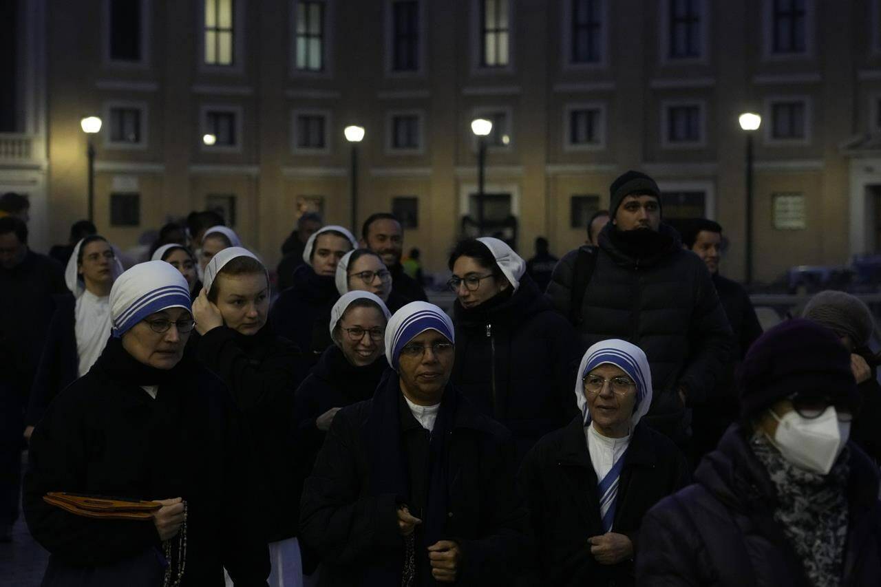 Nuns arrive at dawn to view the body of Pope Emeritus Benedict XVI as it lies in state in St. Peter’s Basilica at the Vatican, Wednesday, Jan. 4, 2023. The Vatican announced that Pope Benedict died on Dec. 31, 2022, aged 95, and that his funeral will be held on Thursday, Jan. 5, 2023. (AP Photo/Gregorio Borgia)