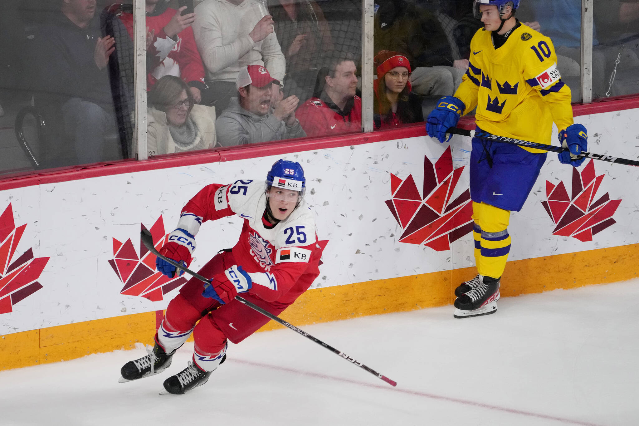 Jiri Kulich of Czechia, left, celebrates his game-winning goal in front of Fabian Wagner of Sweden during overtime of IIHF World Junior Hockey Championship semifinal action in Halifax on Wednesday, January 4, 2023. THE CANADIAN PRESS/Darren Calabrese
