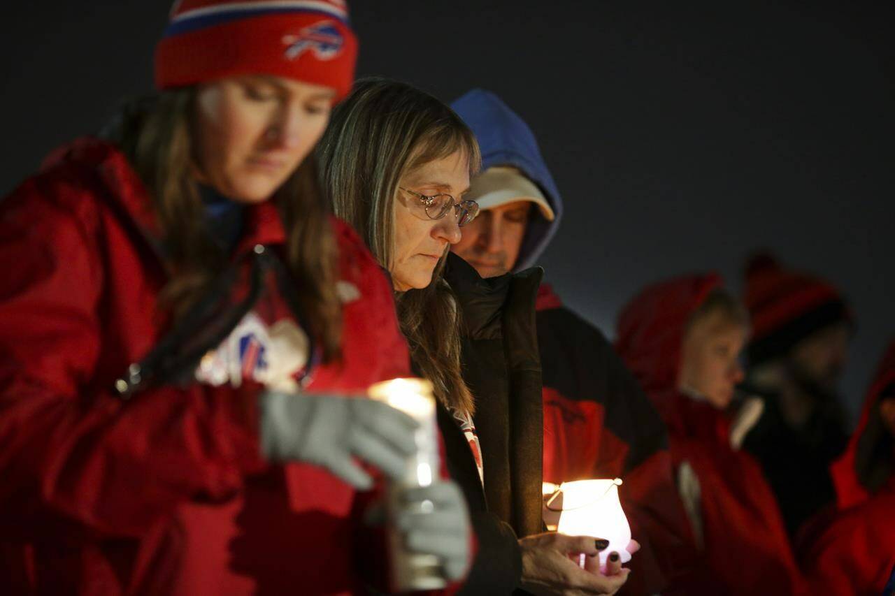 Buffalo Bills fans and community members gather for a candlelight vigil for Buffalo Bills safety Damar Hamlin on Tuesday, Jan. 3, 2023, in Orchard Park, N.Y. (AP Photo/Joshua Bessex)
