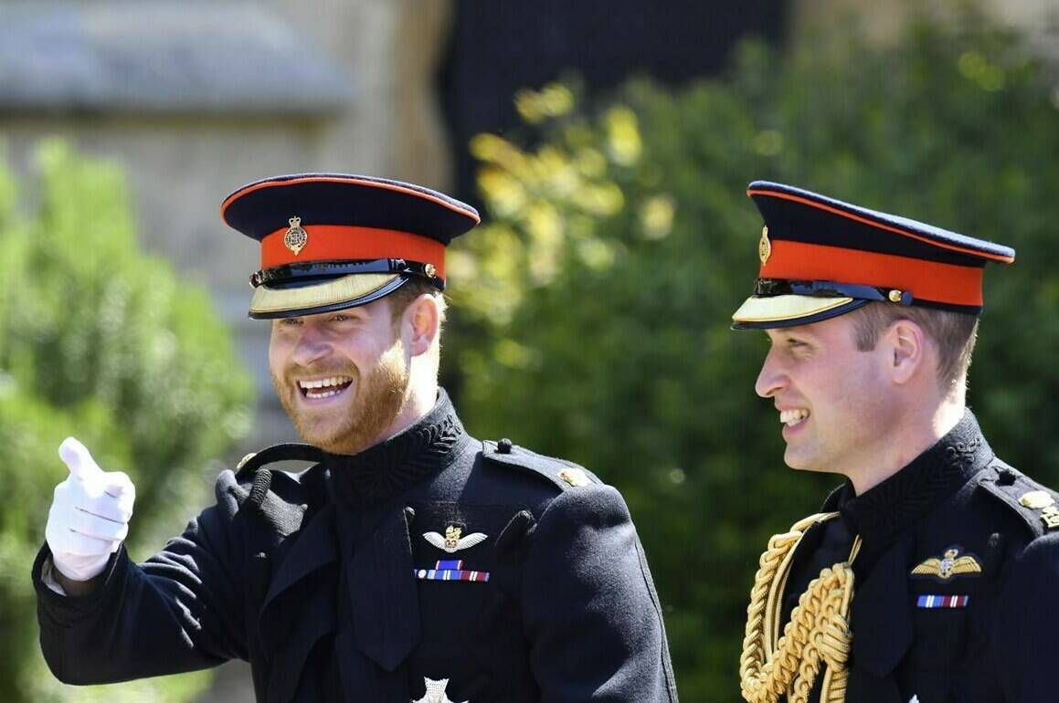 FILE - Britain’s Prince Harry, left, reacts as he walks with his best man, Prince William the Duke of Cambridge, as they arrive for the the wedding ceremony of Prince Harry and Meghan Markle at St. George’s Chapel in Windsor Castle in Windsor, near London, England, Saturday, May 19, 2018. Prince Harry has said he wants to have his father and brother back and that he wants “a family, not an institution,” during a TV interview ahead of the publication of his memoir. The interview with Britain’s ITV channel is due to be released this Sunday. (Ben Birchhall/pool photo via AP, File)