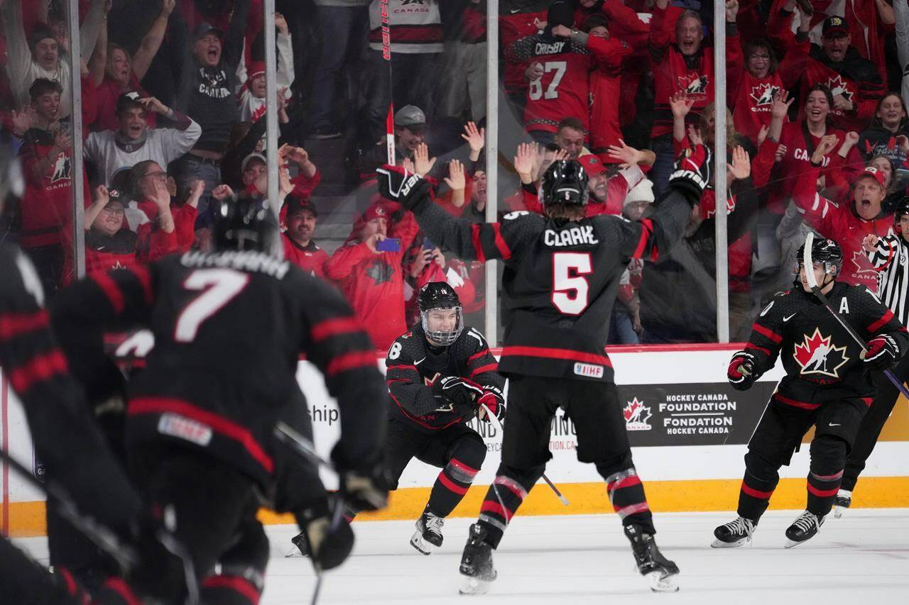 Canada’s Connor Bedard, centre, reacts with teammates after scoring the game-winning goal in overtime of IIHF World Junior Championship quarterfinal action against Slovakia in Halifax, Monday, Jan. 2, 2023. THE CANADIAN PRESS/Darren Calabrese