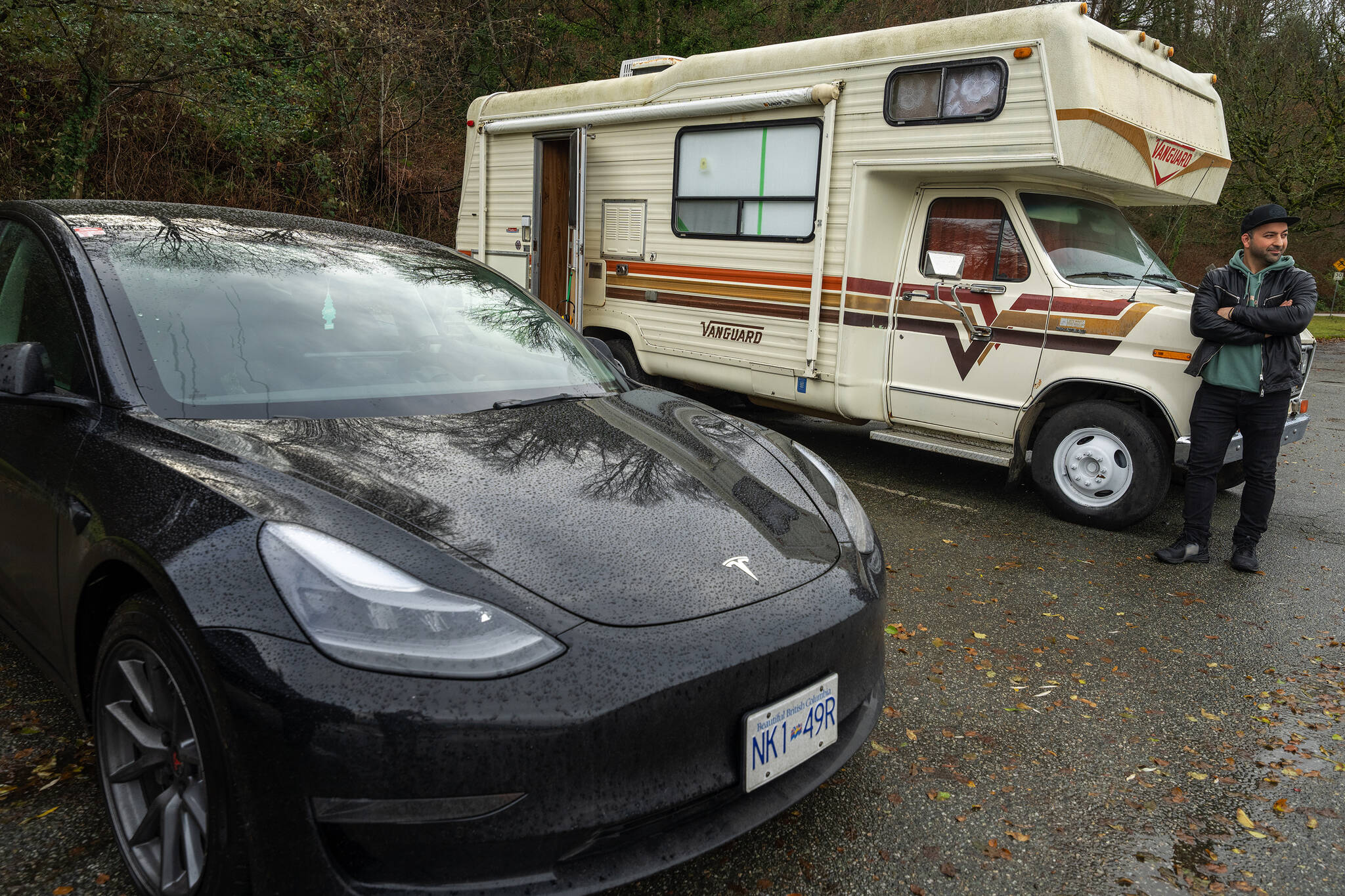 Lucas Philips is pictured outside of his camper and next to his Tesla where he lives in a parking lot in Spanish Banks, in Vancouver, B.C., Thursday, Dec. 8, 2022. Philips lives in a van but drives a Tesla, as part of Metro Vancouver’s growing camper community. THE CANADIAN PRESS/Jonathan Hayward