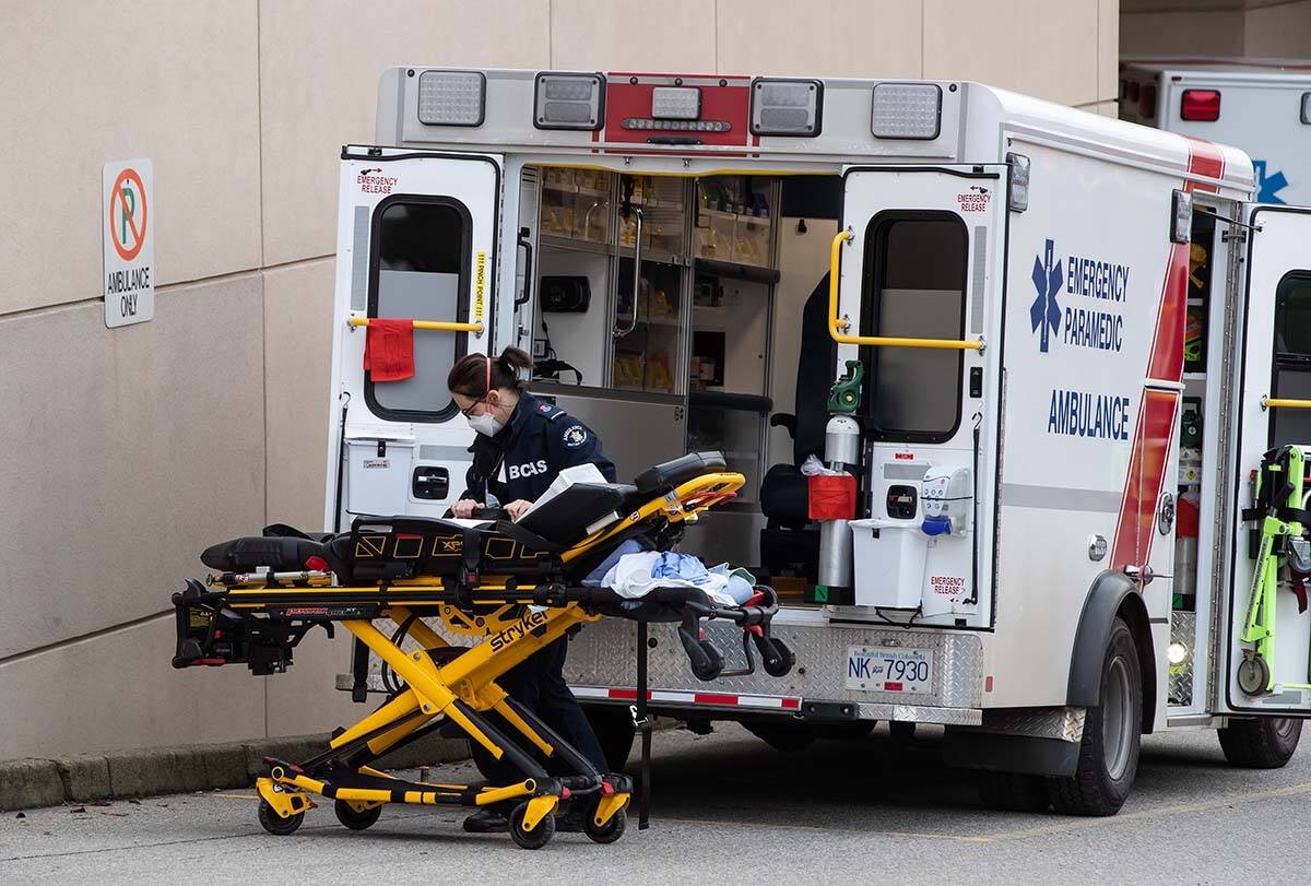 A B.C. Ambulance Service paramedic moves a stretcher outside an ambulance at Royal Columbia Hospital, in New Westminster on Nov. 29, 2020. The paramedics union has reached a tentative new agreement with BCEHS and the province as of Jan. 6, 2023. THE CANADIAN PRESS/Darryl Dyck