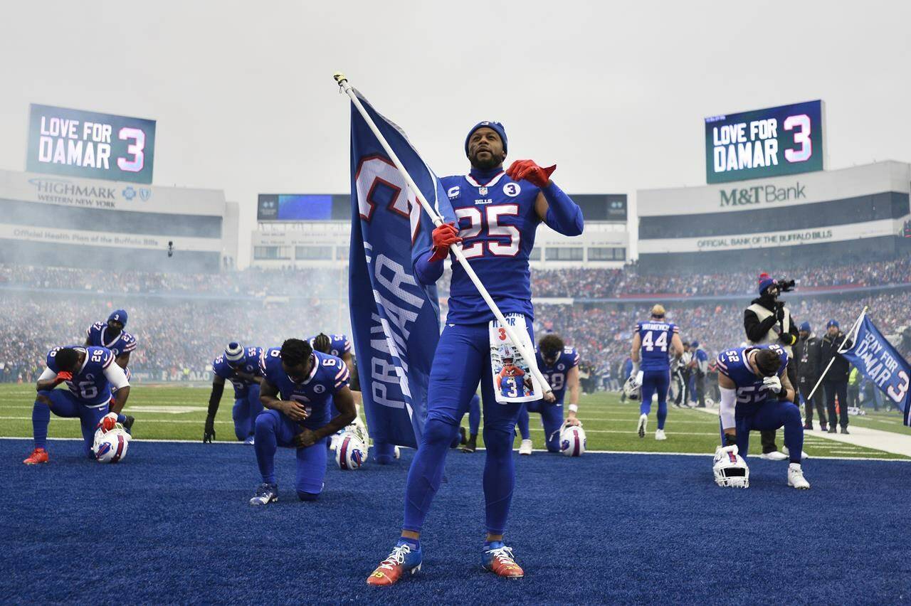 Buffalo Bills running back Taiwan Jones (25) kneels in prayer for safety Damar Hamlin before an NFL football game against the New England Patriots, Sunday, Jan. 8, 2023, in Orchard Park, N.Y. Hamlin remains hospitalized after suffering a catastrophic on-field collapse in the team’s previous game against the Cincinnati Bengals. (AP Photo/Adrian Kraus)
