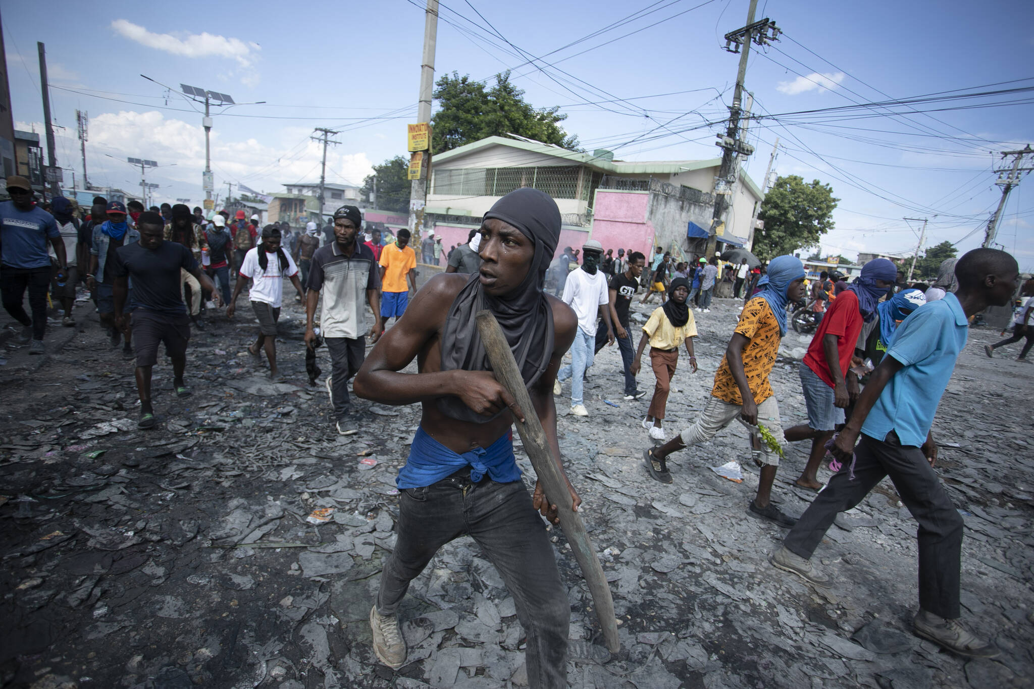 A protester carries a piece of wood simulating a weapon during a protest demanding the resignation of Prime Minister Ariel Henry in the Petion-Ville area of Port-au-Prince, Haiti, on Oct. 3, 2022.The Canadian Armed Forces have sent armoured vehicles to Haiti that were purchased by Port-au-Prince. Foreign Affairs Minister Mélanie Joly and Defence Minister Anita Anand say the equipment will help the Haitian National Police to try containing a gang crisis.THE CANADIAN PRESS/AP-Odelyn Joseph