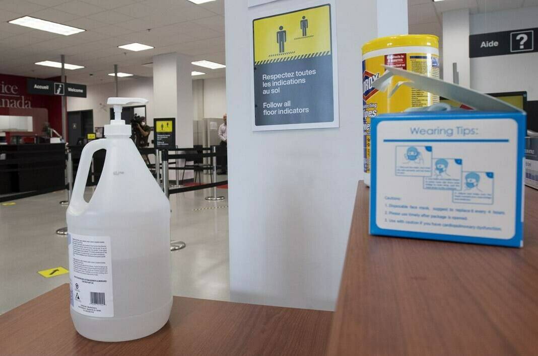 Hand sanitizer, face masks and wipes are available at the entrance of a Service Canada office Tuesday July 7, 2020 in Gatineau, Quebec. Provinces are awash with expired hand sanitizer that Ottawa sent them during the height of the COVID-19 pandemic.THE CANADIAN PRESS/Adrian Wyld