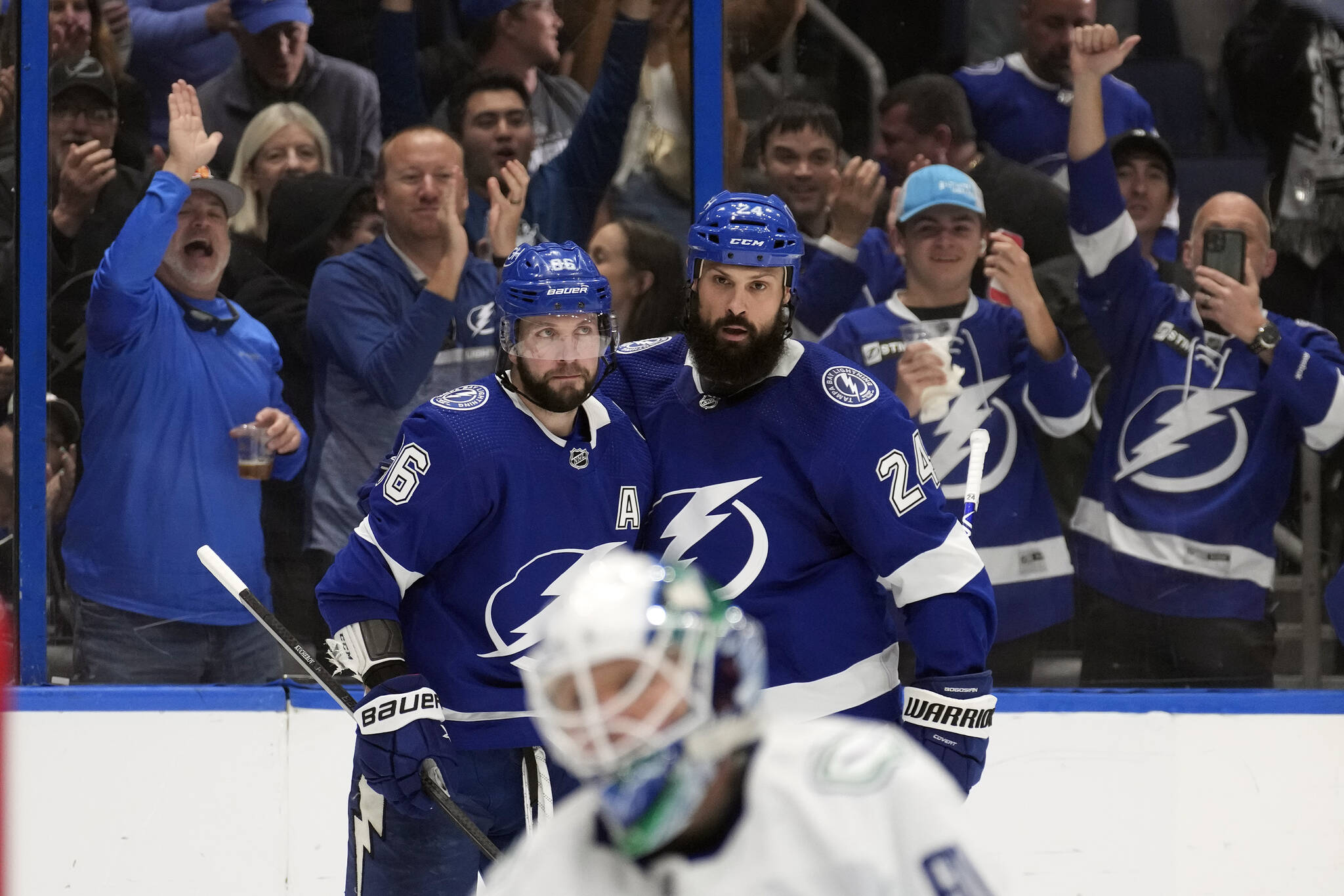 Tampa Bay Lightning right wing Nikita Kucherov (86) celebrates his goal against the Vancouver Canucks with defenseman Zach Bogosian (24) during the second period of an NHL hockey game Thursday, Jan. 12, 2023, in Tampa, Fla. (AP Photo/Chris O’Meara)