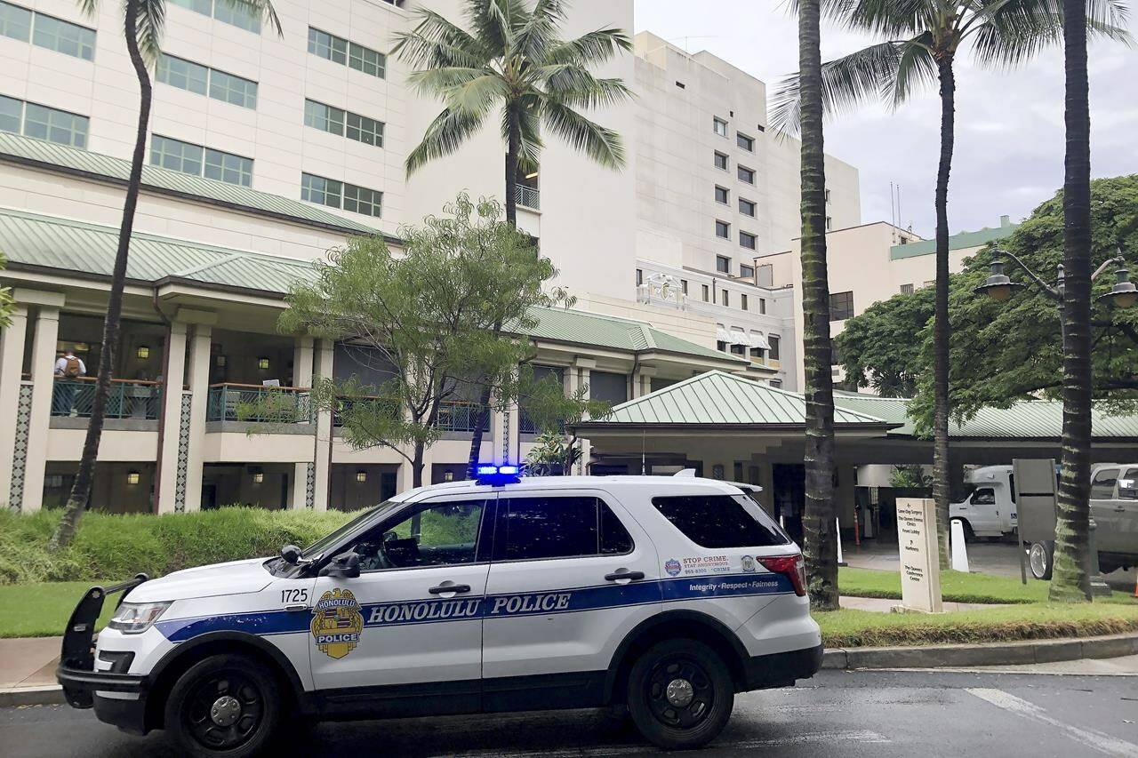 FILE - A Honolulu Police vehicle is parked outside of The Queen’s Medical Center, where some patients injured by air turbulence on a Hawaiian Airlines flight from Phoenix to Honolulu were taken, Sunday, Dec. 18, 2022, in Honolulu. A preliminary report by the National Transportation Safety Board released Friday, Jan. 13, 2023, says the pilots of a Hawaiian Air plane that hit severe turbulence last month told investigators they had less than three seconds to react after a cloud shot up vertically in front of them at 38,000 feet on an otherwise clear day. Twenty-five people were injured in the Dec. 13, 2022, incident, including six who were seriously hurt. (AP Photo/Audrey McAvoy, File)